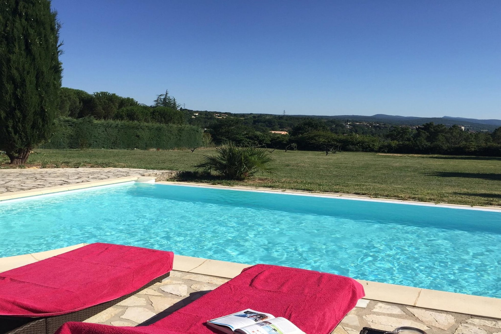 There’s a special quiet that settles over this villa the moment you step through the gate - sun on the terrace, trees shading the lush garden and a private heated infinity pool that promises easy afternoons. Tucked into the gentle hills near Barjac, the house feels both private and well-placed for exploring southern France.

Spread across two floors, the layout is designed for relaxed group living. On the ground floor, an open kitchen flows into a comfortable living–dining room with TV, billiards table and a dining area - a warm hub for shared meals. The master bedroom lies on the ground floor with its attached full bathroom, including a bathtub, plus a separate guest toilet for added ease.
Upstairs, there are 2 further bedrooms – furnished with two double beds - each paired with a private bathroom, which makes the house ideal for families or friends travelling together. Practical comforts include air conditioning, internet, private parking, washing facilities, and a dedicated workspace for anyone who needs it.

Outside becomes your own little resort - a fenced garden, terrace with barbecue and dining furniture, sun loungers, an outdoor shower, and bicycles for local rides. The estate also offers fitness equipment, a drying cabinet and thoughtful touches like room-darkening shades.

When you want to explore, Barjac’s medieval streets, artisan shops and weekly markets invite slow wandering through the Ardèche gorges, vineyards, with river activities being an easy drive for day trips. Return home to swim, grill, and watch the evening light settle over the garden - the kind of Provençal stay that feels quietly complete.