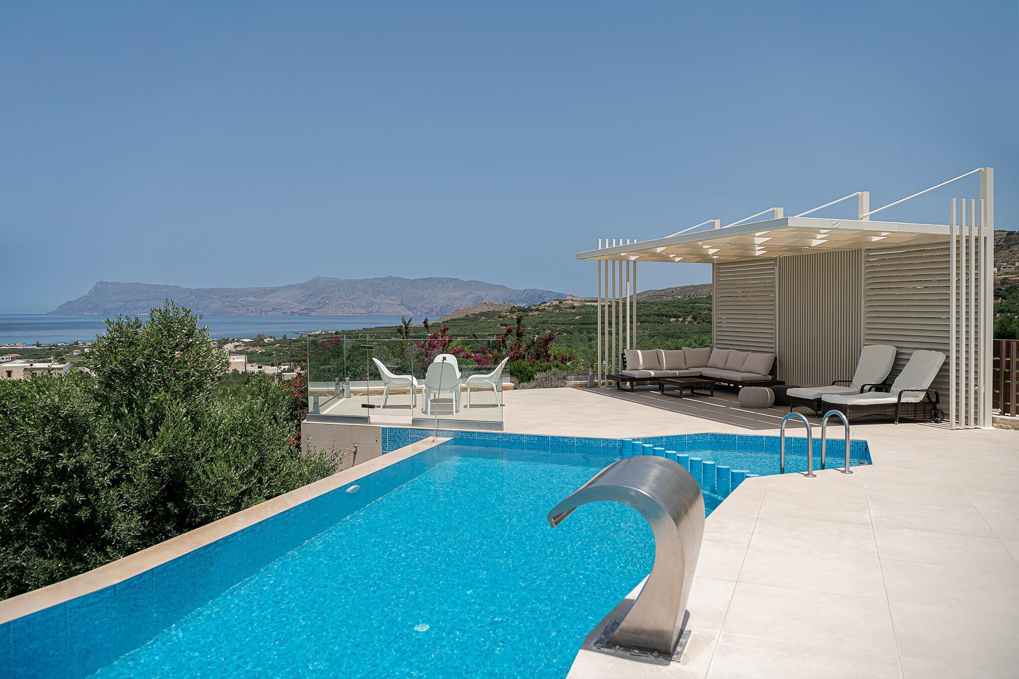 Picture yourself arriving at a quiet lane of olive trees, stone walls and smiling Cretan warmth. This villa sits just outside a small village near the sleepy town of Kissamos - a peaceful stay where sea-breeze, rugged coastline and quiet nights set the tone for a getaway that’s relaxed, real and full of possibilities.

Stepping into the villa, you’re welcomed by spacious interiors where comfort meets elegance. The layout includes four cozy bedrooms and three bathrooms, arranged for up to 8 guests to stay with ease. Every room is designed to feel natural and modest - with stone and wood details, soft lighting, and plenty of space to unwind. A bright living area merges with a modern kitchen - equipped and ready for home-cooked meals.

Outside, the villa unfolds several amenities, a private infinity pool overlooking greenery and the distant sea, perfect for slow mornings with coffee or lazy afternoons. A sun terrace and garden space give you spots to lounge, read, share meals, or watch stars after dinner.

When you’re ready to explore, the western coast of Crete opens up for you many options - Golden-sand beaches, hidden coves and blue waters - from relaxed sunbathing to snorkelling and boat rides, all within minutes’ reach. Local tavernas, sea-facing lunches, fresh seafood and coastal walks bring a slower, richer rhythm to your days.

Villa Aloni is a quiet slice of Crete where people gather, sea and sky become the backdrop, and memories are made between sunlight, olive trees and soft sea breeze.