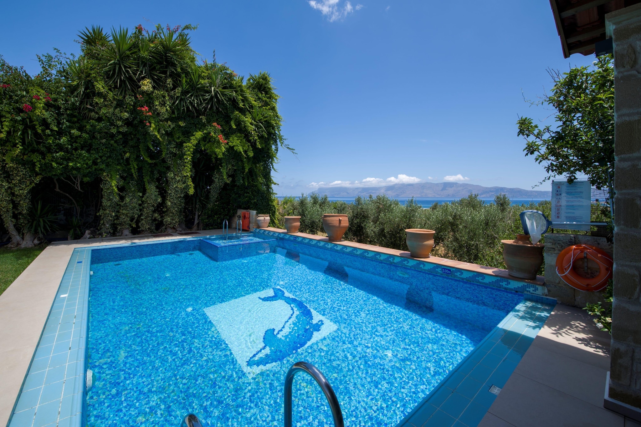 Imagine a place where lemon trees, bougainvillea and sea breeze meet stone walls, wooden ceilings, and a private pool under the open sky - that’s the feel of Villa Arhontariki at Kissamos Luxury Villas. Nestled in the peaceful village of Kalyviani, this place invites a group of friends or a big family to share a blend of comfort, space and Crete’s timeless charm.

When you step inside, you’ll find a warm, inviting home carefully furnished, where every room flows into shared spaces that encourage togetherness. Villa Arhontariki spans three levels, and comfortably accommodates up to 7 guests - three bedrooms each with a double bed and one bedroom with a single bed and three full bathrooms. On the ground floor, there’s a fully equipped kitchen, a spacious living room with a fireplace and a large wooden dining table - ideal for group meals and relaxed evenings, a cozy game room and a fitness corner next to the garden and pool area. Outside, a heated swimming pool and a well-tended garden with shaded seating areas invite you for slow mornings, poolside lunches or sunset drinks under the Cretan sky. Additional amenities include WiFi, Barbecue, sun loungers and on-site parking.

From here, you’re just a short drive from Kissamos town and its port. Local tavernas, small markets and beautiful beaches are close by - perfect for spontaneous trips to the sea or seaside dinners after a day of exploring. 

Villa Arhontariki is more than a place to stay; it’s a warm, spacious home where you can cook together, laugh around the table, swim under the stars, and explore Crete’s western coast with ease.