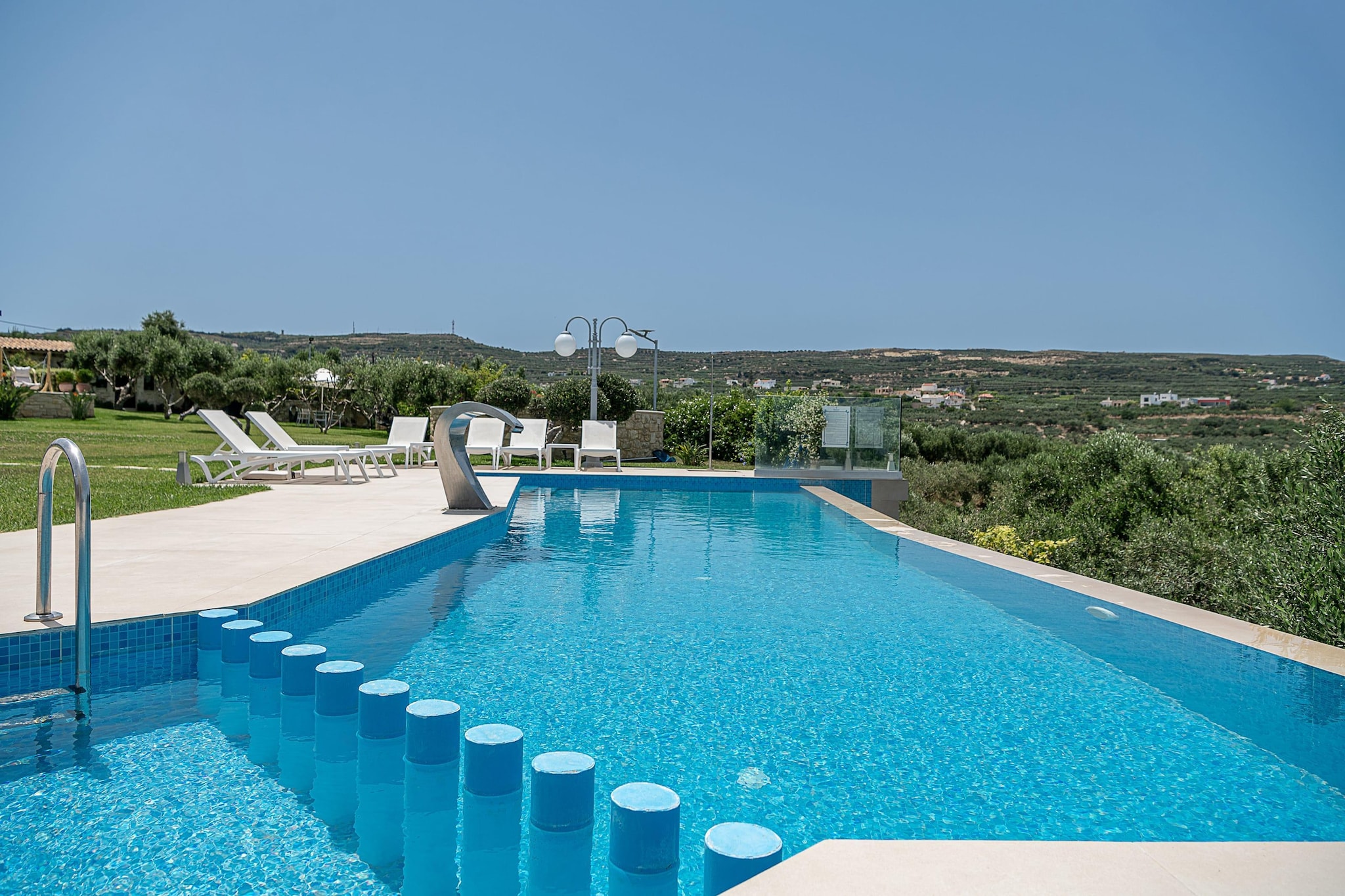 Picture yourself at a quiet lane of olive trees, stone walls and smiling Cretan warmth. This villa sits just outside a small village near Kissamos - a peaceful stay where sea-breeze, rugged coastline and quiet nights set the tone for a getaway that’s relaxed, real and full of possibilities.

Stepping into the villa, you’re welcomed by spacious interiors where comfort meets elegance. The layout includes three cozy bedrooms, two with a double bed, and one with a single bed and two full bathrooms, set for up to 5 guests. Every room is designed to feel natural and modest, with stone and wood details, soft lighting. A bright living area merges with a modern kitchen - equipped and ready for home-cooked meals.

Outside, the villa unfolds several amenities, a private pool overlooking greenery and the distant sea, perfect for slow mornings with coffee or lazy afternoons. A sun terrace and garden space give you spots to lounge, read, share meals, or watch stars after dinner. Additional amenities include Wifi, TV and a fireplace.

When you’re ready to explore, the western coast of Crete opens up for you many options - Golden-sand beaches, hidden coves and blue waters - from relaxed sunbathing to snorkelling and boat rides, all within minutes’ reach. Local tavernas, sea-facing lunches, fresh seafood and coastal walks bring a slower, richer rhythm to your days.

Villa Aloni is a quiet slice of Crete where people gather, sea and sky become the backdrop, and memories are made between sunlight, olive trees and soft sea breeze.