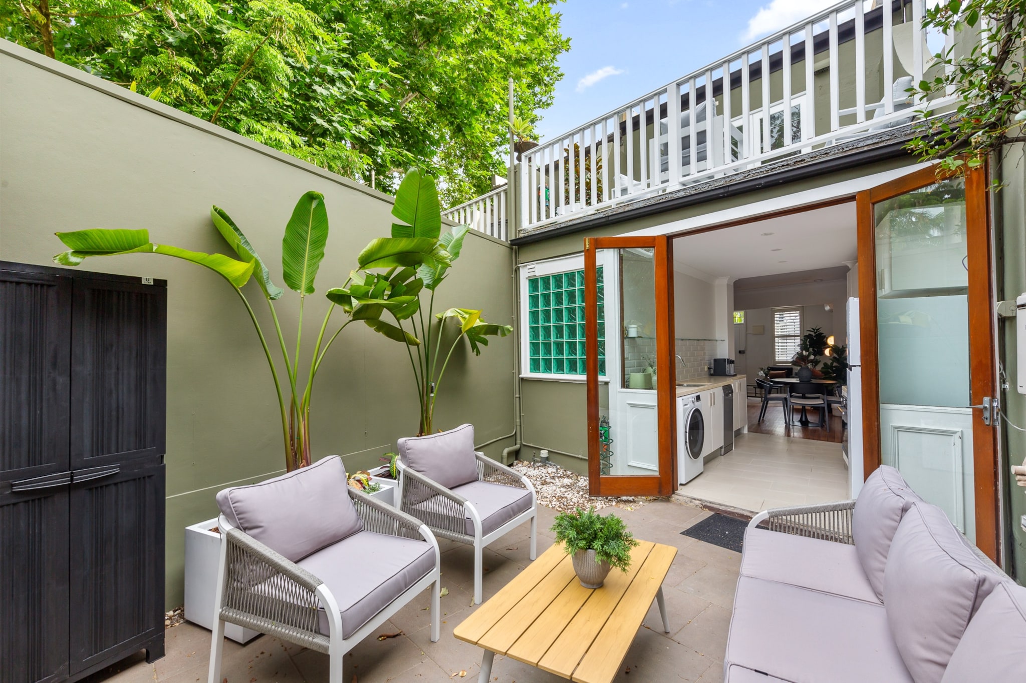 Property description
Enjoy the comfort of this bright and spacious 2-bedroom Surry Hills house, ideally located near trendy restaurants and cafés. Featuring keyless entry for seamless self check-in, this home offers a private balcony, stylish interiors and a peaceful backyard oasis, making it a perfect urban escape.
The space
Step into a charming and light-filled home designed for both relaxation and convenience. The open living area offers a cosy lounge with ample seating, a smart TV, and stylish touches like a modern rug and decorative accents. A wooden dining table with seating for four invites you to gather over home-cooked meals, easily prepared in the fully equipped gas kitchen.
Each of the two bedrooms is fitted with a queen bed, blackout blinds, heaters, air conditioning, and ample bedding and storage—ensuring a restful night’s sleep. The bathroom is neat and modern, with all the essentials for a comfortable stay.
Enjoy your morning coffee on the private balcony or unwind in the backyard, complete with outdoor seating and a private BBQ. Whether you’re here for work or leisure, this home blends comfort and location effortlessly.