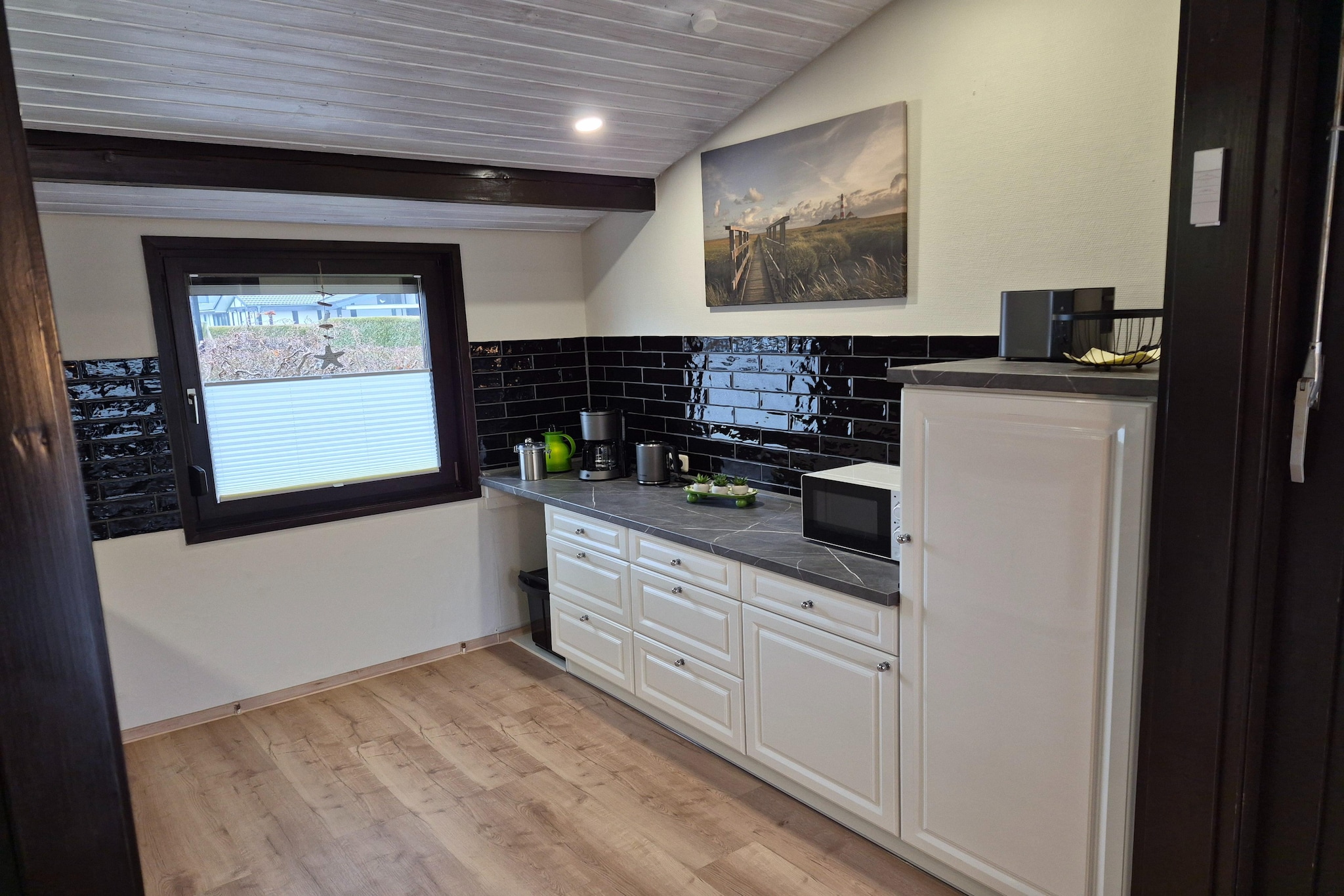 Ground floor: (open kitchen(electric kettle, toaster, cooker(4 ring stoves, ceramic), coffee machine, oven, microwave, dishwasher, fridge), Living/diningroom(TV, dining table, fireplace, seating area), bedroom(double bed), bedroom(single bed, single bed), bathroom(bath tub, shower, washbasin, toilet), storage)\n\ncarport, baby bath(paid), terrace, garden furniture, parking, stair gate, Laundry Package for a fee
