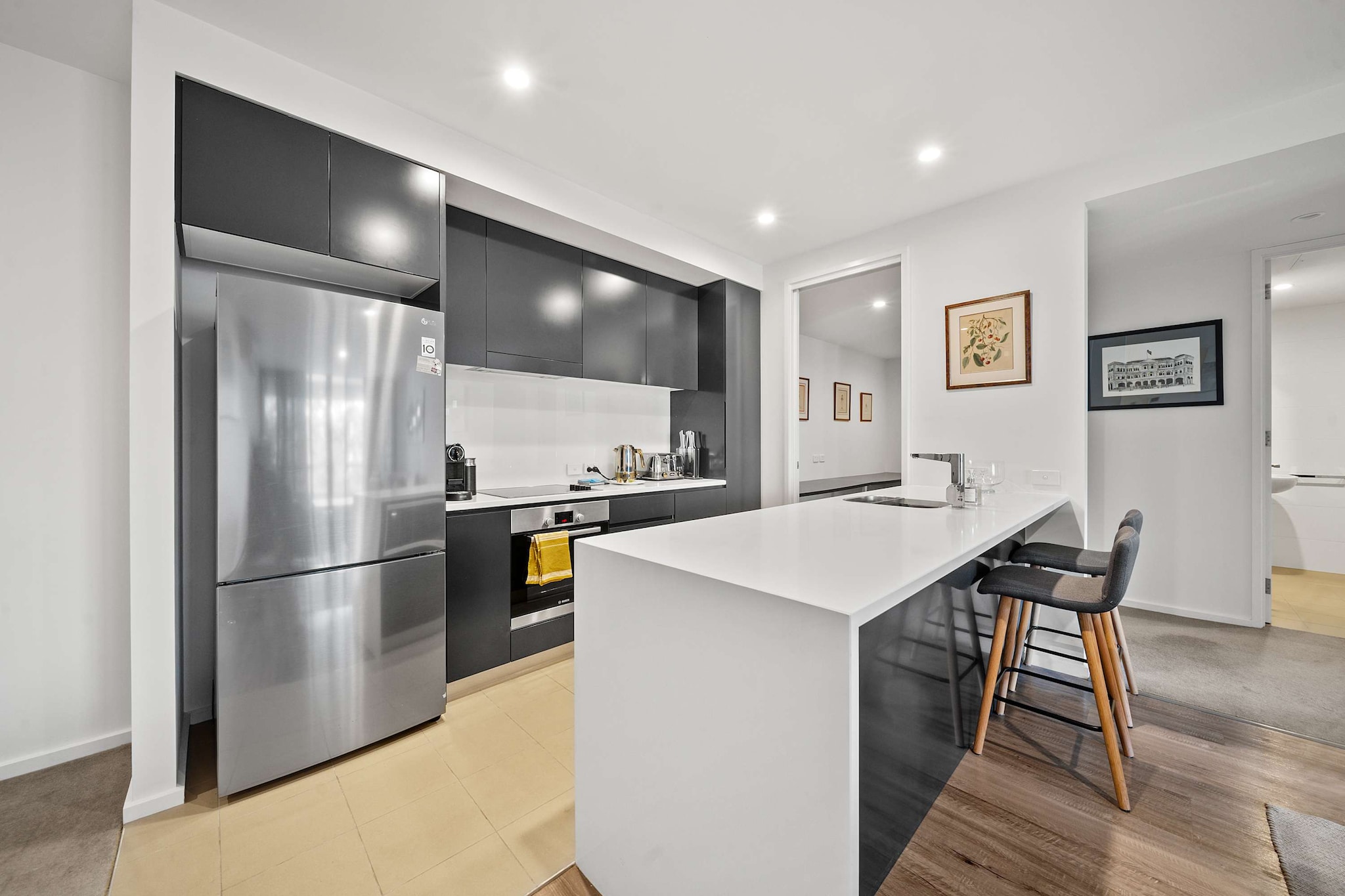 Property description
Set in Canberra’s vibrant Kingston Foreshore, this modern 1-bedroom apartment features a full study room and private balcony with BBQ. With spacious interiors and rooftop garden access, it’s perfect for both work and leisure. Enjoy a peaceful escape just moments from cafés, restaurants, and Lake Burley Griffin. Includes seamless self check-in via Keynest.
The space
Step into a spacious, light-filled apartment designed for comfort and convenience. The living area features a three-seater lounge, smart TV with streaming options, and timber flooring throughout. A sleek dining area offers seating for six, with two additional stools at the kitchen counter for casual meals.
 
The queen-sized bedroom is cosy and inviting, complete with blackout blinds, ample storage, and soft lighting. The modern en-suite bathroom is fully equipped with essentials, while a second bathroom adds extra convenience.
 
Adjacent to the kitchen, the dedicated study room includes a desk and sofa bed, making it ideal for remote work or accommodating an extra guest. The full kitchen features electric cooking, a dishwasher, microwave, and capsule coffee machine.
 
Step outside to your private balcony, where you’ll find a BBQ and outdoor seating—perfect for al fresco dining or enjoying a quiet evening. The rooftop garden on level 4 offers additional shared outdoor space, accessible via the central lifts.
 
With secure underground parking, internal laundry facilities, and a welcoming ambience, this property is a serene retreat in one of Canberra’s most desirable neighbourhoods.