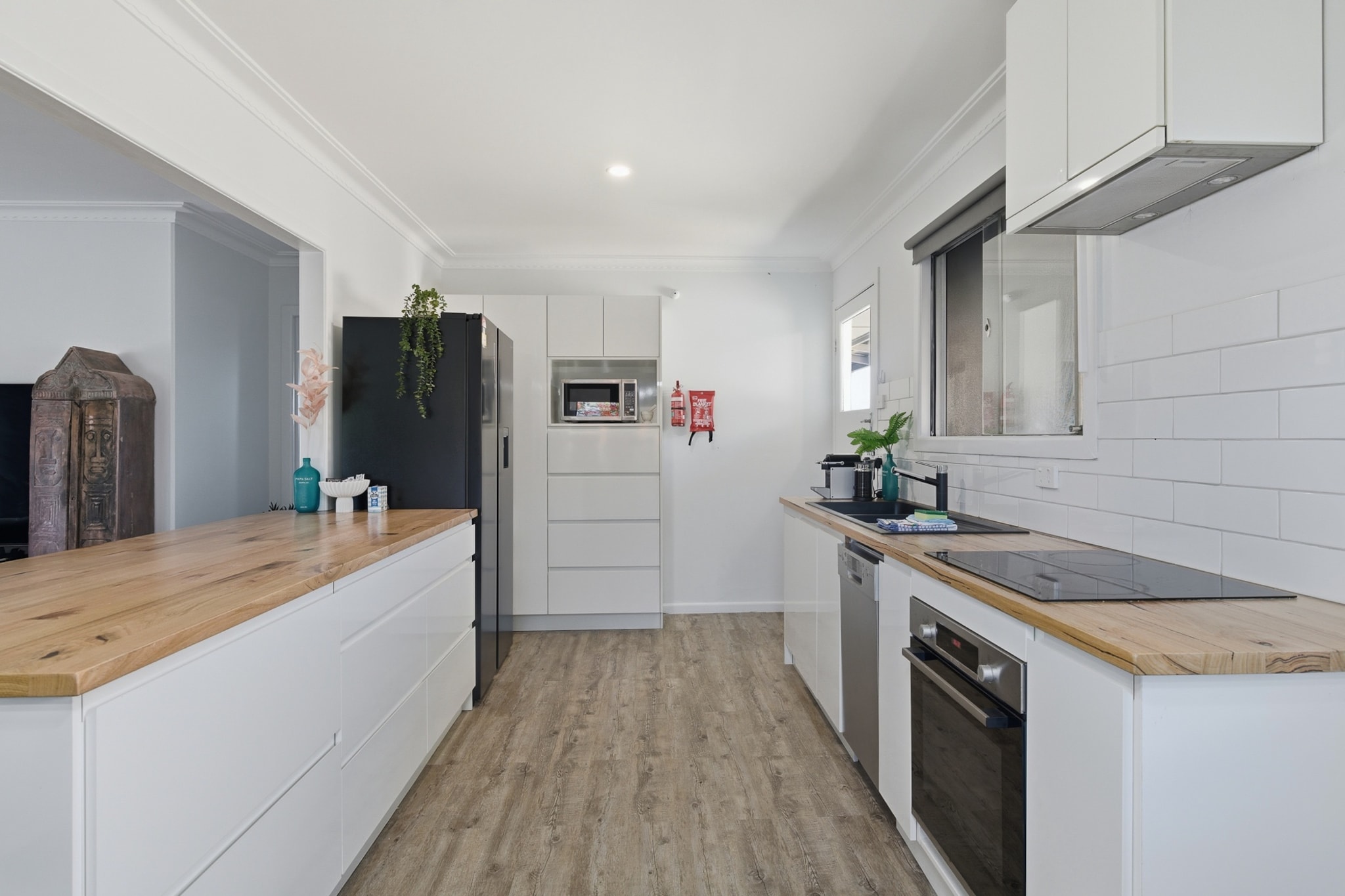 Property description
This light-filled townhouse offers a tranquil coastal escape with a stylish interior and garden patio. Enjoy seamless self-check-in via lockbox and make the most of Margate’s beachside charm. With spacious bedrooms, inviting living spaces, and a private BBQ, it’s perfect for families or small groups looking to relax in comfort and explore the local area.
The space
Step into a bright and modern townhouse that effortlessly blends coastal charm with everyday comfort. The open-plan living area is beautifully styled with contemporary furniture, a large couch, and an entertainment setup including a Smart TV. A generous dining space seats six, flowing into a fully equipped kitchen with an electric stovetop, oven, and all essential cookware for home-style meals.
 
Upstairs, three thoughtfully designed bedrooms offer a mix of queen and single beds, soft bedding, bedside tables with lamps, and ample storage. Fans provide comfort across all rooms. The home includes a full bathroom with modern fixtures and quality amenities.
 
Outdoor living is just as appealing, with a private garden and decked patio—ideal for morning coffees or evening BBQs using the gas grill. The home also includes a private laundry, making longer stays easy.
 
With natural lighting, stylish touches, and all the essentials, this home promises a comfortable stay just moments from Margate’s coastal highlights.