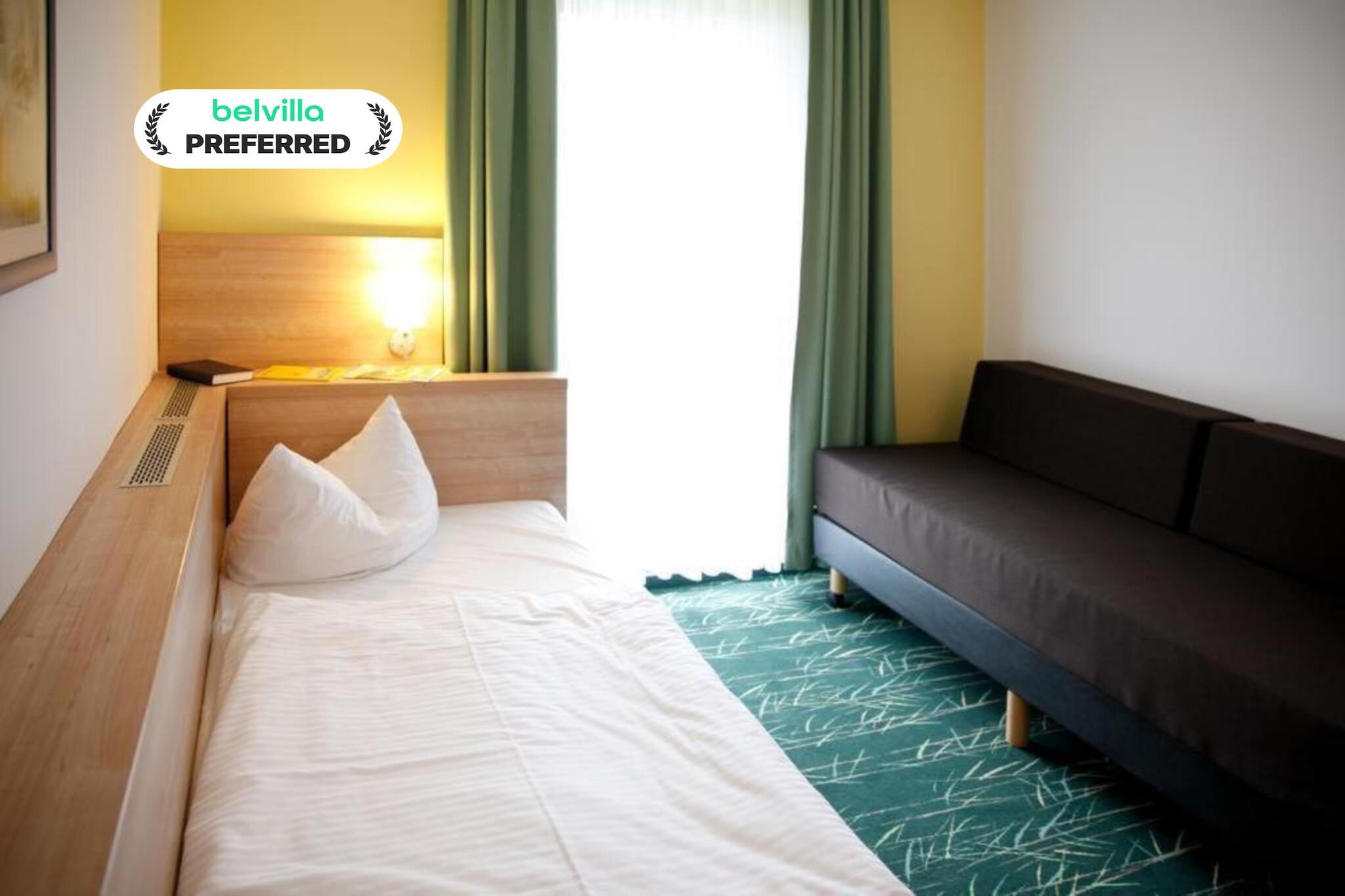 Nestled within the tranquil landscapes of the Feldberg Lake District, this single room at Kaiserhof Feldberg by Belvilla Resorts is a peaceful retreat designed for solo travellers seeking comfort, privacy, and fresh countryside air. Surrounded by shimmering lakes, forest trails, and the calm atmosphere of a Kneipp spa town, it offers a relaxed base to unwind after a day outdoors or a quiet getaway focused on rest and simplicity.
Single Room Features – A Calm Space for One
1. Bright living and sleeping area with a comfortable single bed
2. Private bathroom with shower, washbasin, toilet, and hairdryer
3. Flat-screen TV with cable and satellite channels, including Netflix
4. Cozy seating area ideal for reading or relaxing
5. Free internet access and efficient heating
6. Access to terrace and garden with sun loungers
7. Non-smoking room with a clean, uncluttered layout
8. Pet-friendly (additional charge of 12 Euro/pet/night
Hotel Amenities & Guest Facilities
1. Games and leisure options including billiards, darts, archery, mini golf, water sports, cycling, hiking, horse riding, fishing, and evening entertainment
2. Landscaped garden and terrace areas
3. On-site restaurant and bar
4. Lift access to all floors
5. Paid parking Euros 5 per vehicle per day
6. Friendly reception available from 6:00 to 11:00 in the morning and from 15:00 to 18:00 in the afternoon
7. Guest support services
Nearby Attractions
1. Feldberg Lake and town church within walking distance
2. Kneipp Spa Park approx. 150 m away
3. Forest trails and cycling routes throughout the Feldberg Lake District
4. Schloss Tornow approx. 47 km
5. Neubrandenburg University of Applied Sciences approx. 35 km
How to Reach
1. By train to Neustrelitz or Neubrandenburg, followed by bus or taxi
2. By regional bus connections to Feldberg
3. By air via Heringsdorf Airport, approx. 117 km away