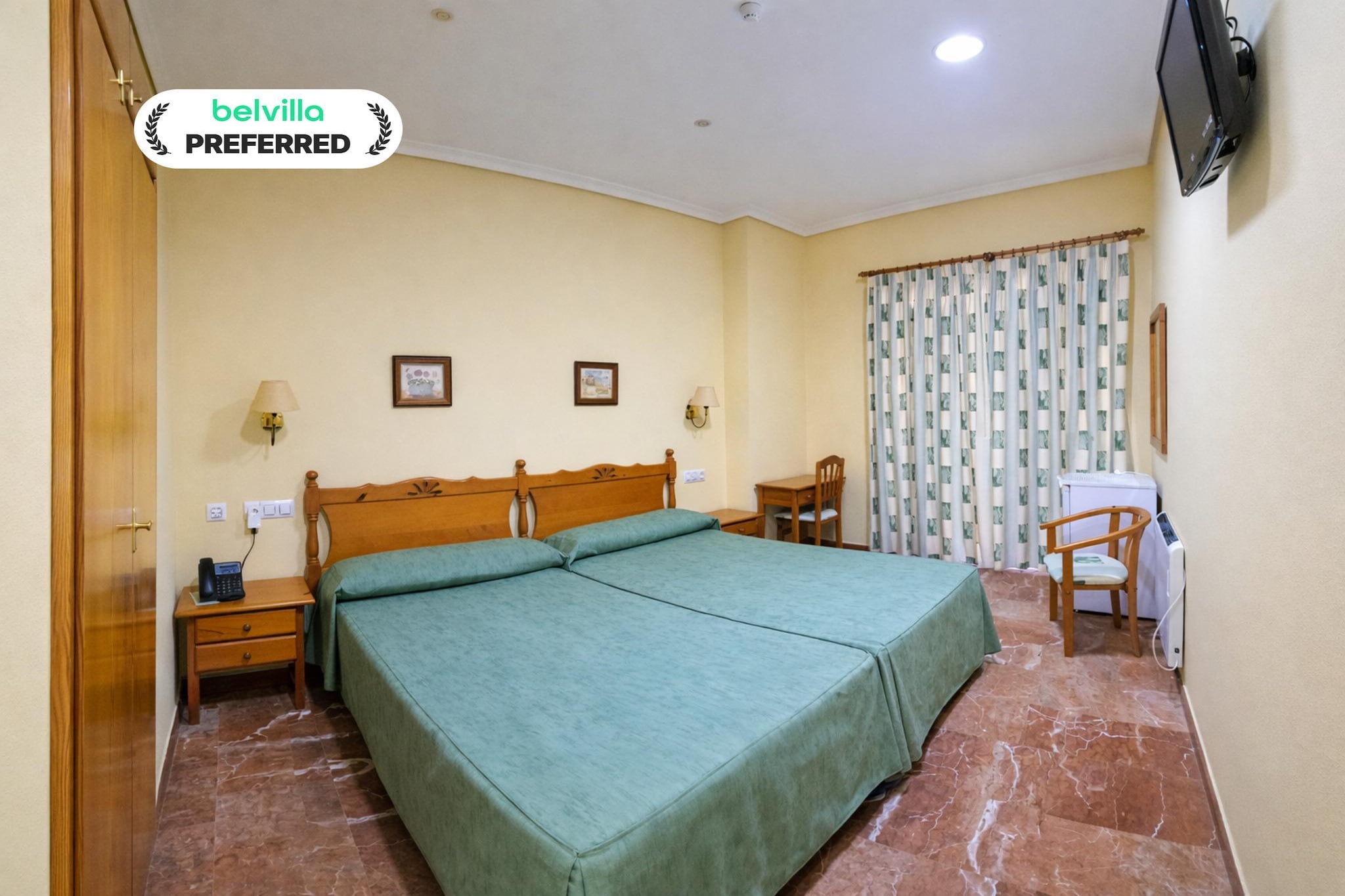 Located in the heart of Santiago de la Ribera, Albohera Playa Hotel by Belvilla Resorts offers a relaxed coastal stay just moments from the Mar Menor. The Double Room is a comfortable choice for couples, friends, or travellers who appreciate extra space, pleasant city views, and a calm Mediterranean atmosphere close to the sea.

Room features – Double Room
1. Spacious 20 m² room with two comfortable single beds
2. City view with good natural light
3. Private bathroom with shower or bath
4. Bidet, hairdryer, toilet paper, and complimentary toiletries
5. Air conditioning and heating for year-round comfort
6. Flat-screen TV and telephone
7. Refrigerator for added convenience
8. Desk and wardrobe or closet
9. Safety deposit box
10. Wake-up service available on request
11. Towels and fresh bed linen provided
12. Socket near the bed and ironing facilities
13. Interconnected rooms available on request
14. Entire unit wheelchair accessible
15. Upper floors accessible by elevator or stairs
16. Non-smoking room

Hotel amenities & guest services
1. Free high-speed Wi-Fi throughout the hotel
2. Breakfast service available
3. On-site restaurant, café, and bar
4. Fitness center
5. 24-hour reception and luggage storage
6. Airport shuttle service available on request (extra charge)
7. Soundproofed rooms and family-friendly options
8. Facilities for guests with reduced mobility
9. Daily housekeeping service
10. Secure access with CCTV and in-room safe
11. Languages spoken: English, Spanish, Portuguese

Nearby attractions & activities
1. Mar Menor beaches with calm, shallow waters
2. Seafront promenade for walking and cycling
3. Water sports such as sailing and windsurfing
4. Local cafés, restaurants, and shops within walking distance
5. Golf course within 3 km (extra charge)

How to reach
1. Murcia International Airport, approximately 35 minutes by car
2. Easy access by local buses and taxis
3. Airport shuttle available on request