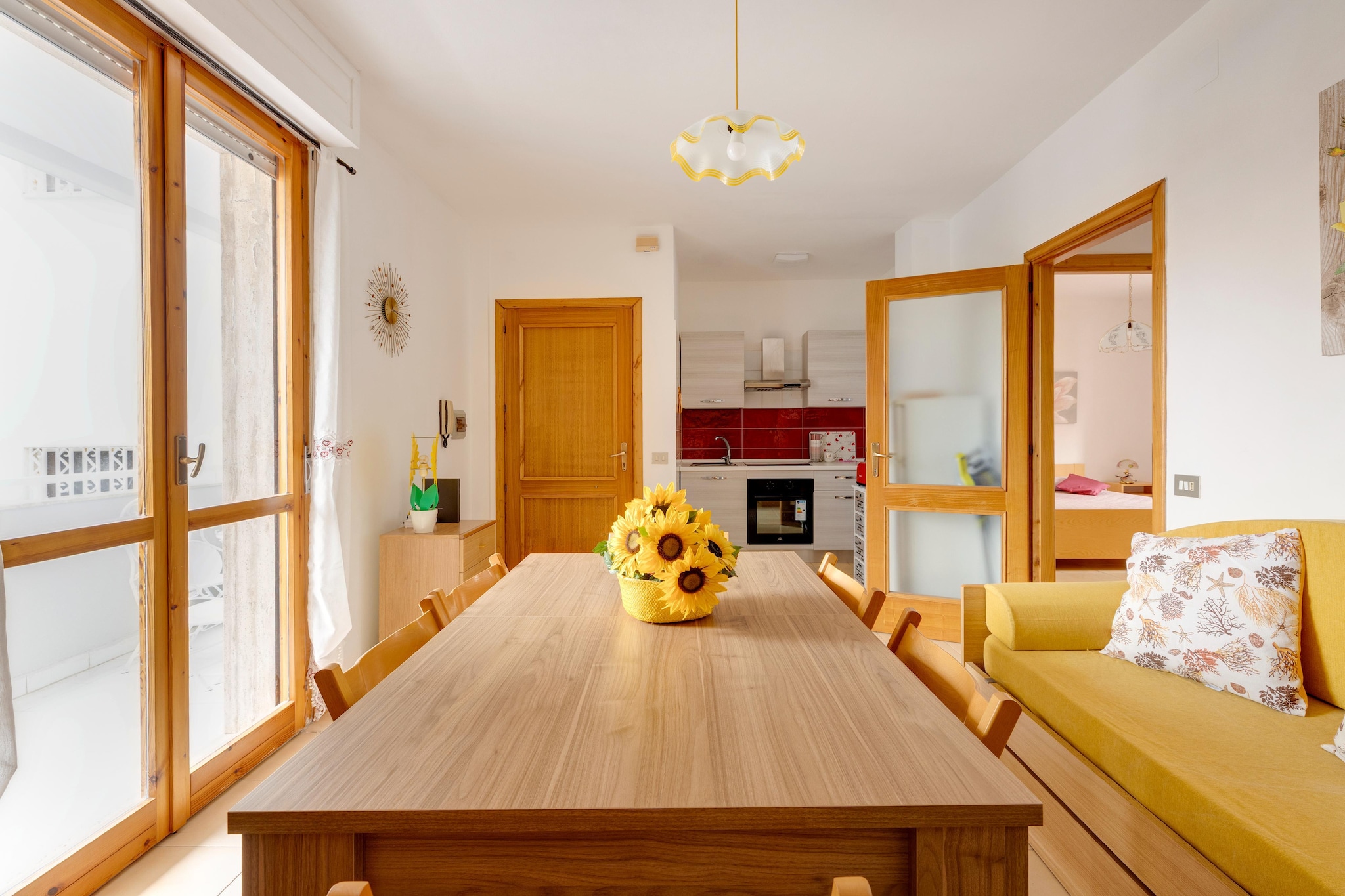 On the 1st floor: (open kitchen(hob(induction), toaster, hood, oven, fridge-freezer, washbasin), Living/diningroom(single sofa bed, TV, dining table), bedroom(double bed), bedroom(single bed, single bed), bathroom(shower, washbasin, toilet, washing machine), balcony, air conditioning)