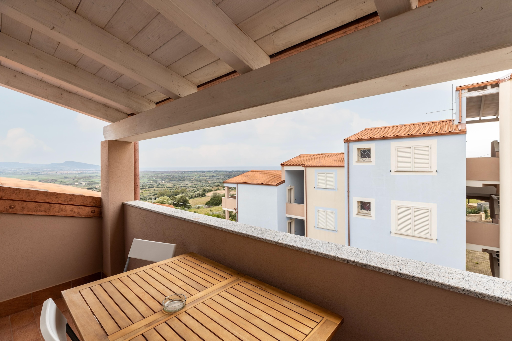 ATTICO BADESI CON PISCINA-View in summer