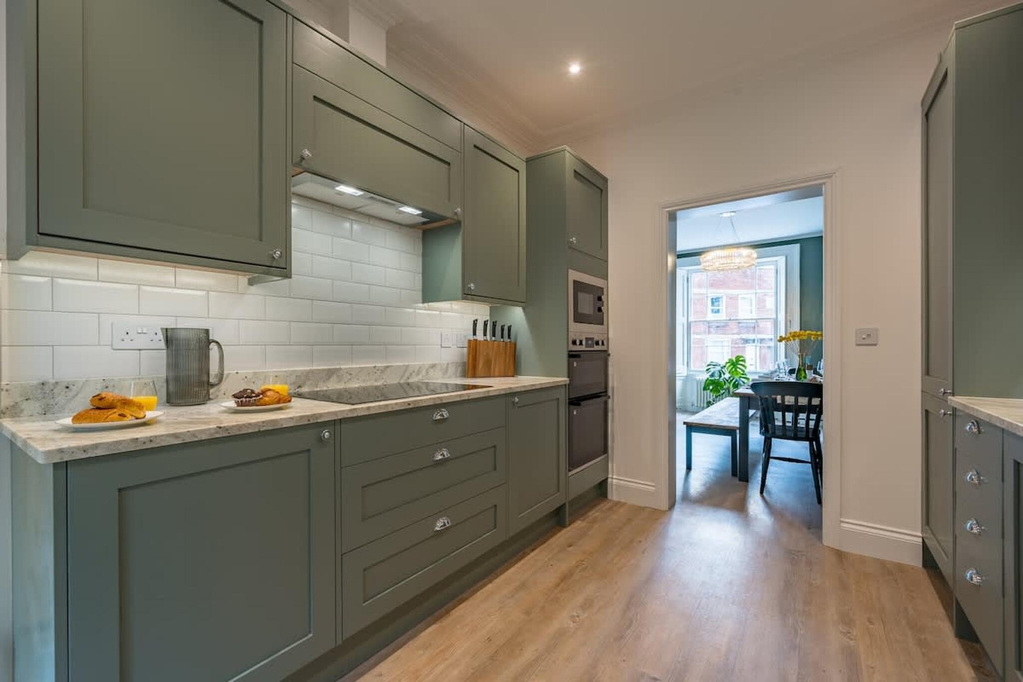Set in the elegant Georgian quarter of Clifton, Bristol, this spacious detached townhouse for eight guests is designed for group stays where comfort, privacy, and shared moments matter equally. Whether you’re visiting with family, friends, or for a special occasion, the layout offers room to gather and room to unwind.

Inside, the living room provides a relaxed setting with comfortable seating and a huge TV for quiet evenings, while a separate dining room with a large table becomes the natural hub for meals, games, and long conversations. The open kitchen is fully equipped with an oven, dishwasher, and fridge-freezer, making group cooking easy and sociable rather than crowded. All four bedrooms feature double beds, with the first bedroom also offering a TV for added comfort. Three fully functional bathrooms with bathtubs ensure smooth mornings and unhurried evenings for everyone in the group. A private garden for shared moments and soaking in the sun.

The home is thoughtfully equipped for longer stays and mixed needs, including Wi-Fi, a dedicated workspace, a washer-dryer, heating, a high chair, room-darkening shades, and an indoor play area. Public parking nearby adds practical convenience in this central location.

Step outside and you’re moments from the iconic Clifton Suspension Bridge, scenic walks across the Avon Gorge, and the green viewpoints of Brandon Hill, Bristol. The lively Bristol Harbourside is also within easy reach, filled with cafés, restaurants, boat tours, and cultural spots. This is a stay that combines city character, historic charm, and the ease of a well-planned home base for groups.