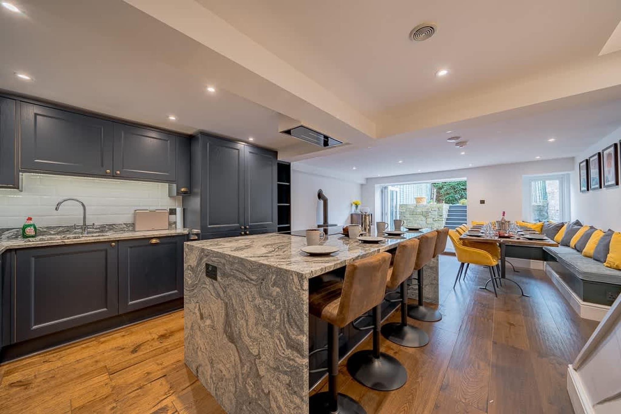 Located in the elegant heart of Bath, this generously sized six-bedroom home is perfectly set up for large families, friend groups, celebrations, and special getaways. With beautifully designed interiors, ample sleeping space, and thoughtful communal areas, the house balances privacy with togetherness.

The living room welcomes you with comfortable seating, a TV, and a fireplace that adds warmth and character to relaxed evenings indoors. A separate dining room with a large table makes shared meals easy and memorable, while the fully equipped open kitchen is ready for everything from quick breakfasts to group dinners. Across six bedrooms, guests will find plush, comfortable beds and ample storage space. Four bedrooms offer double beds, while two larger rooms feature king-size beds for added comfort and luxury. The first bedroom also includes a TV. Three fully functional bathrooms with bathtubs ensure convenience for bigger groups, helping mornings run smoothly.

Step outside to enjoy the private garden and terrace - an ideal setting for morning coffee, evening drinks, or simply unwinding in the fresh air. Practical amenities such as Wi-Fi, heating, a washer-dryer, an indoor play area, and nearby public parking make this home suitable for both short breaks and longer stays.

From here, you’re perfectly placed to explore the architectural beauty of Royal Crescent, stroll past the iconic Pulteney Bridge, admire Bath Abbey, or wander through the landscaped views of Prior Park Landscape Garden. Cafés, restaurants, nightlife, and historic attractions are all within easy reach, making this a stylish and convenient base for discovering everything Bath has to offer.