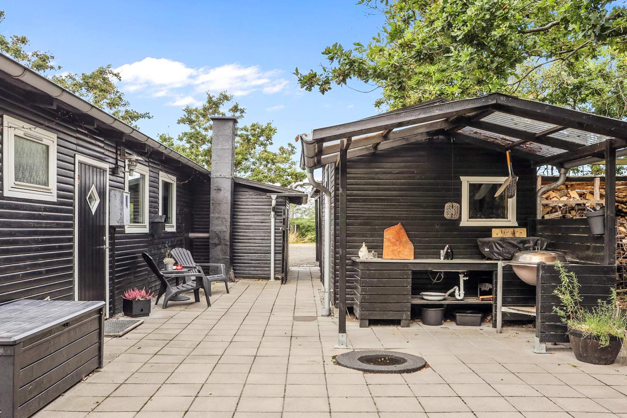 Just a few minutes' walk from the peaceful coast of the Limfjord, this well-located holiday home is situated in scenic Trend – an ideal retreat for tranquillity, togetherness and outdoor life. The child-friendly beach is close by and invites you to play in the water and take peaceful walks along the shore, while the holiday home itself provides a safe base in green surroundings. Inside, a bright living room with a wood-burning stove awaits – perfect for cool evenings or games and cosiness after a day by the fjord. The house has three bedrooms, all with double beds, providing ample space for both family and friends. The kitchen is fully equipped with a dishwasher and microwave, making it easy to prepare everything from morning coffee to dinner. The bathroom is simple and functional with a shower and toilet, and after a trip to the beach, you can rinse off the salt water under the outdoor shower. Outside, the garden offers a natural setting with space for play, relaxation and shared meals. Here you will find several cosy corners – garden furniture, a charcoal grill and, last but not least, an outdoor kitchen, which makes summer dining an experience in itself. The tool shed has a washing machine and air fryer for free use, and the carport has both a power socket and a 220 V outlet. With both a heat pump and a wood-burning stove, the house is suitable for stays in several seasons, and the area around Trend is known for its peaceful atmosphere, good swimming opportunities and beautiful nature trails. A wonderful starting point for a holiday focused on togetherness, nature and enjoyment. Rental to youth groups is not permitted.A refundable deposit might be charged closer to your check-in date. The security deposit ensures a smooth stay and covers any additional services or consumption charges.This deposit covers utilities consumed during your stay and any additional services that may be taken.The final amount will be adjusted based on actual meter readings, actual usage of extra services, and any remaining balance will be refunded within 21 days after checkout.This deposit simply acts as a prepayment for charges that  you would anyways pay for, ensuring a seamless stay and check-out experience.