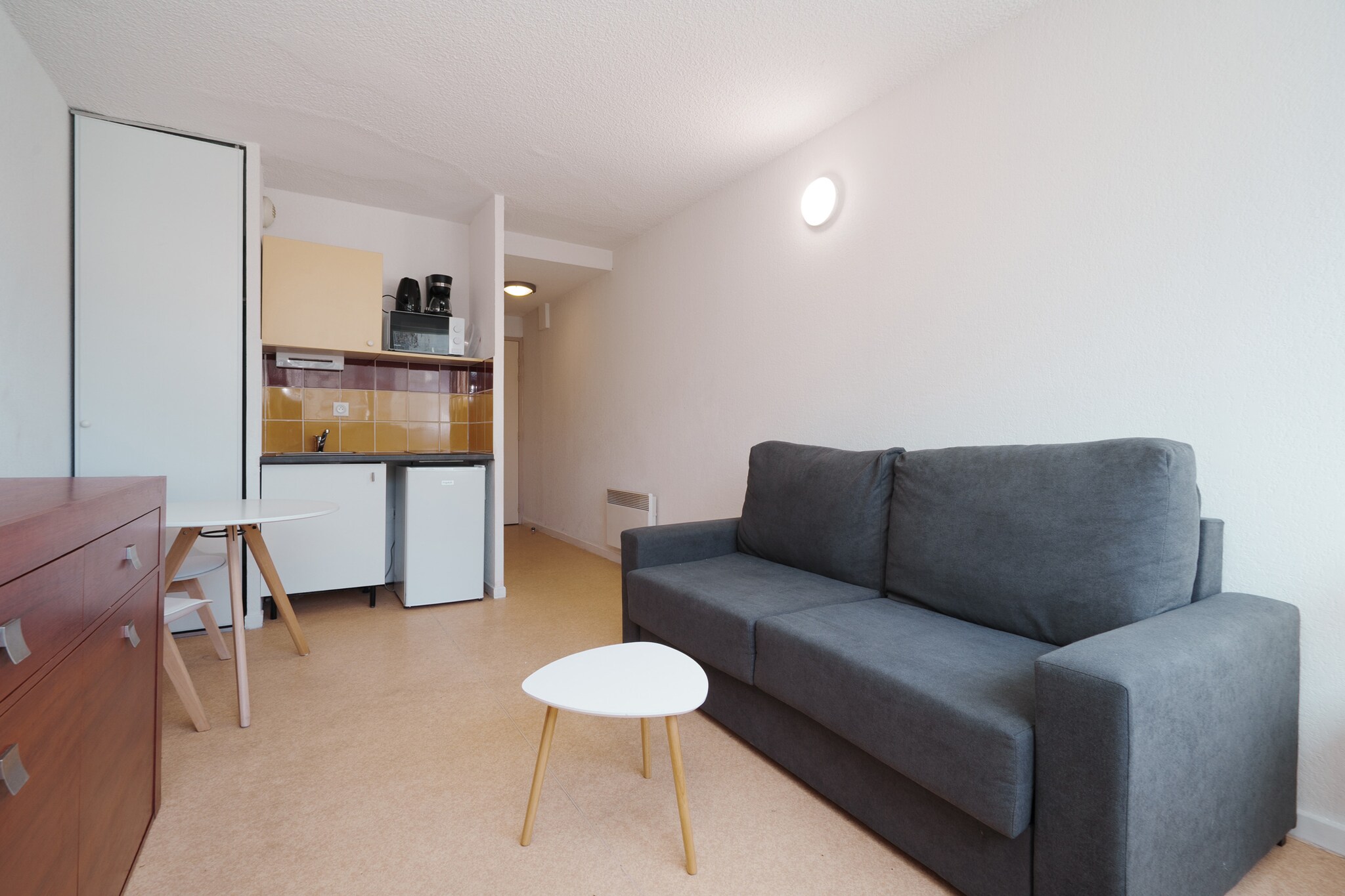 Charming Coastal Living for Two
Experience a bright and airy escape in this charming 19 m² studio apartment, perfectly designed for a romantic getaway or a solo coastal retreat. Bathed in natural light, this compact yet functional living space features a comfortable double sofa bed and a dedicated dining area, creating a warm and inviting atmosphere. Situated in a peaceful residential zone of Agde, the apartment offers the ideal balance of seaside tranquility and modern convenience, serving as a light-filled sanctuary just steps from the Mediterranean shore.

Exceptional Amenities and Heated Pool Access
This studio apartment provides premium building features that elevate your stay, including elevator access and efficient electric heating for year-round comfort. Guests have full access to the heated communal swimming pool, offering a luxurious spot to unwind regardless of the season. The interior is thoughtfully equipped with a full bathroom featuring a bathtub and a well-appointed open-plan kitchen. With a refrigerator, microwave, and a complete coffee station, you have everything needed for a seamless self-catering experience by the sea.

Unbeatable Proximity to the Sea and Sand
Location is everything, and this studio apartment places you at the heart of the best Agde has to offer. You are located just 50 meters from local restaurants and a short 1 km stroll from the pristine sandy beaches. Whether you are looking to spend your days sunbathing, enjoying fresh seafood, or exploring the vibrant residential neighborhood, this property serves as the perfect base. With the sea practically at your doorstep, you can enjoy the ultimate coastal lifestyle with every essential amenity within easy reach.