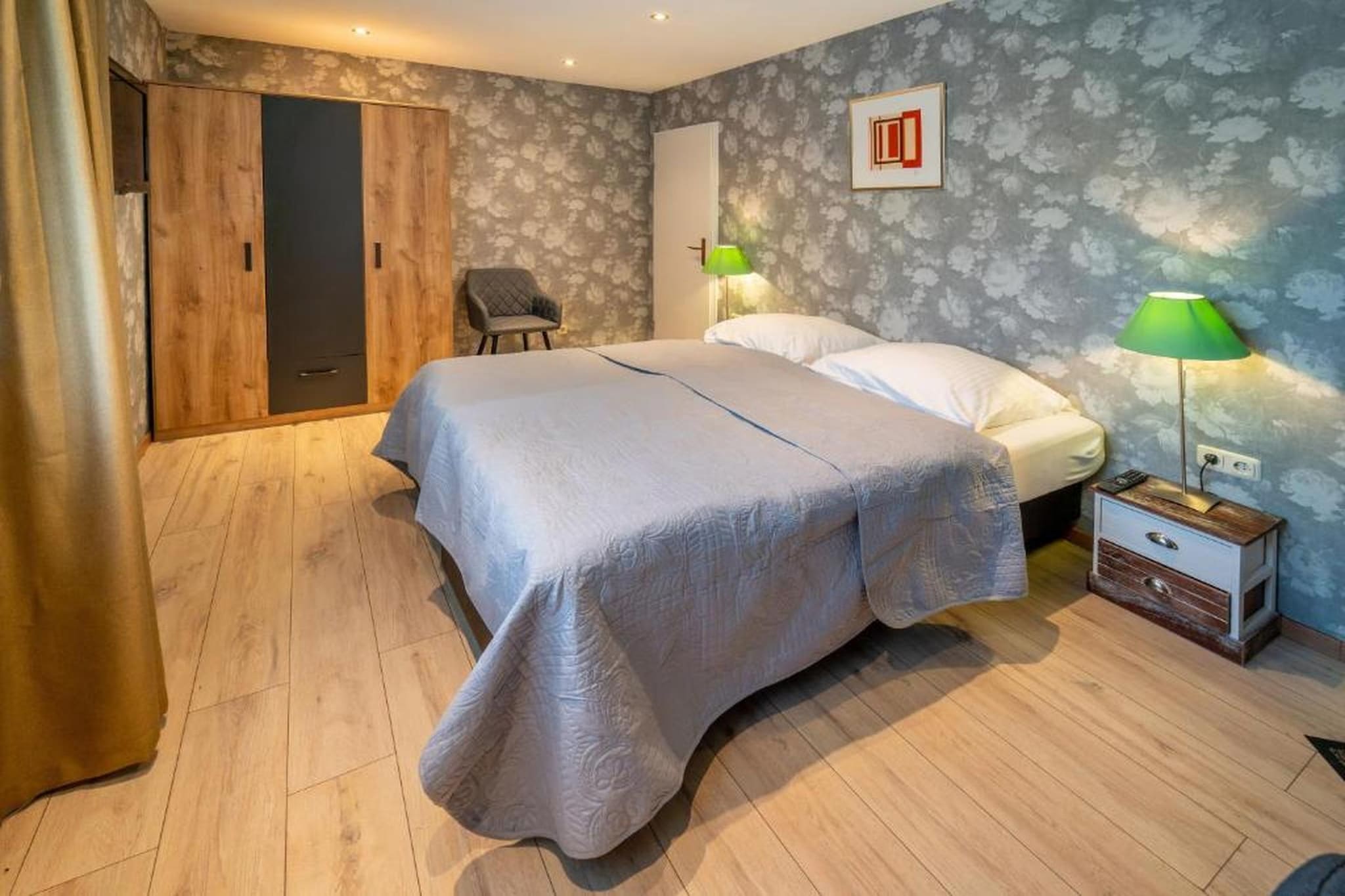 Nestled in the scenic countryside of the Rheinischer Westerwald, the Double Room at Hotel Heiderhof by Belvilla offers a peaceful and comfortable retreat for couples, friends or business travellers. Surrounded by rolling hills and forest trails, the hotel combines rural charm with warm hospitality, making it an ideal base for hiking holidays, short countryside escapes and relaxing stays close to nature.
Room Amenities (20 m² – Garden View)
1. Bright double room with private balcony and garden view.
2. Private bathroom with shower, toilet, towels and hairdryer.
3. Flat-screen TV with satellite and cable channels.
4. Desk and seating area for relaxation or work.
5. Safety deposit box and wardrobe for storage.
6. Hardwood/parquet and carpeted flooring.
7. Hypoallergenic features, heating and linen included.
8. Non-smoking room with stairs access only.
Hotel Amenities
1. On-site restaurant serving Dutch and German cuisine.
2. Bar and coffee house.
3. Sun terrace, garden and picnic area.
4. Shared lounge and games room.
5. Free on-site public parking.
6. Free WiFi in selected rooms.
7. Meeting facilities and laundry service (additional charge).
8. Pets allowed on request (Euros 10 per pet, per day).
Activities
1. Hiking and cycling trails directly from the hotel.
2. Table tennis and indoor games.
3. Billiards and darts (additional charge).
4. Fishing opportunities nearby.
Nearby Areas
1. Altenkirchen Train Station – 19 km.
2. Cologne Bonn Airport – 45 km.
3. Koblenz Theatre – 42 km.
4. Easily accessible by car with free parking.
A relaxing countryside base combining comfort, nature and regional hospitality in the Rheinischer Westerwald.