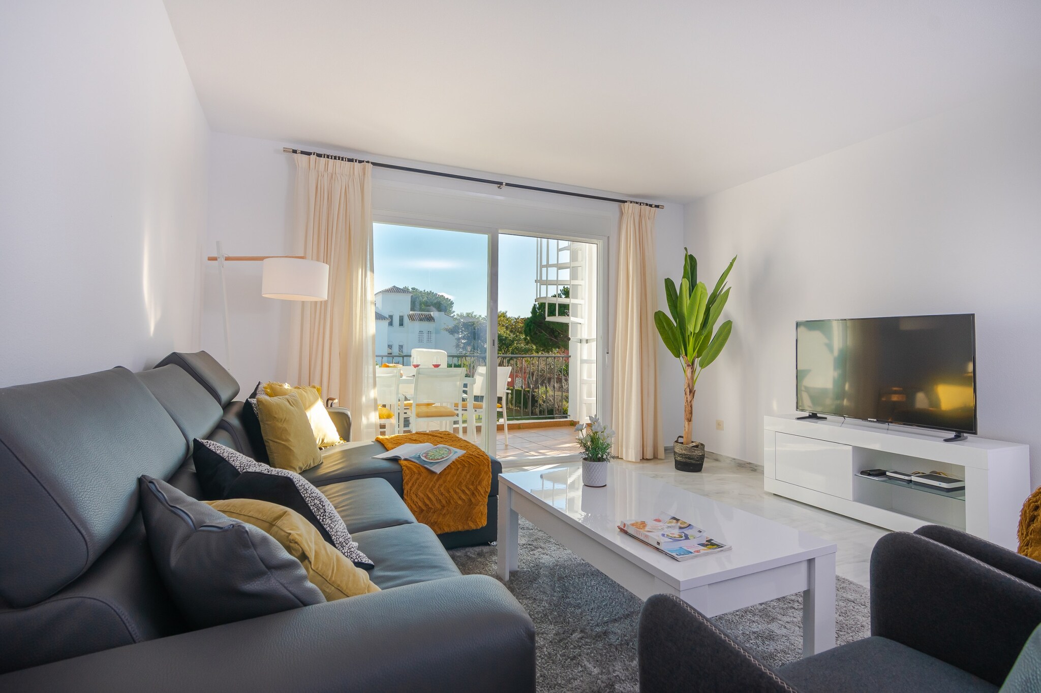 This contemporary beachside penthouse in Estepona offers stylish accommodation for up to six guests, ideally positioned just a short stroll from the golden sands of Cancelada and coastal paths along Spain’s Costa del Sol. The property combines modern design with bright, open living spaces - making it a perfect choice for guests who want sea breezes, easy beach access and outdoor living all in one destination.

Upon entering, you’ll find a fully equipped modern kitchen that opens into a comfortable living and dining area for six, adorned with contemporary furnishings and abundant natural light. Three well-arranged bedrooms accommodate flexible group stays: a master suite with a double bed and en-suite shower, a second bedroom with a double bed, and a third bedroom with two single beds. A shared bathroom supports everyday convenience, while air-conditioning and free Wi-Fi help keep you comfortable throughout your visit.

The penthouse’s outdoor spaces are a standout feature. From the living area, sliding doors lead to a terrace furnished for outdoor dining, perfect for alfresco meals or evening drinks. A staircase leads up to the private rooftop terrace where four sun loungers await, offering a prime spot to soak up the sun or enjoy panoramic sea views after a day on the beach.

Situated in a gated community with landscaped gardens and a communal swimming pool, this penthouse places you within easy reach of Estepona’s beaches, beach clubs and dining options, while also being a short drive from the lively centres of San Pedro and Marbella. With its blend of indoor comfort and inviting outdoor areas, this property makes an excellent base for enjoying the laid-back charm of the Costa del Sol.