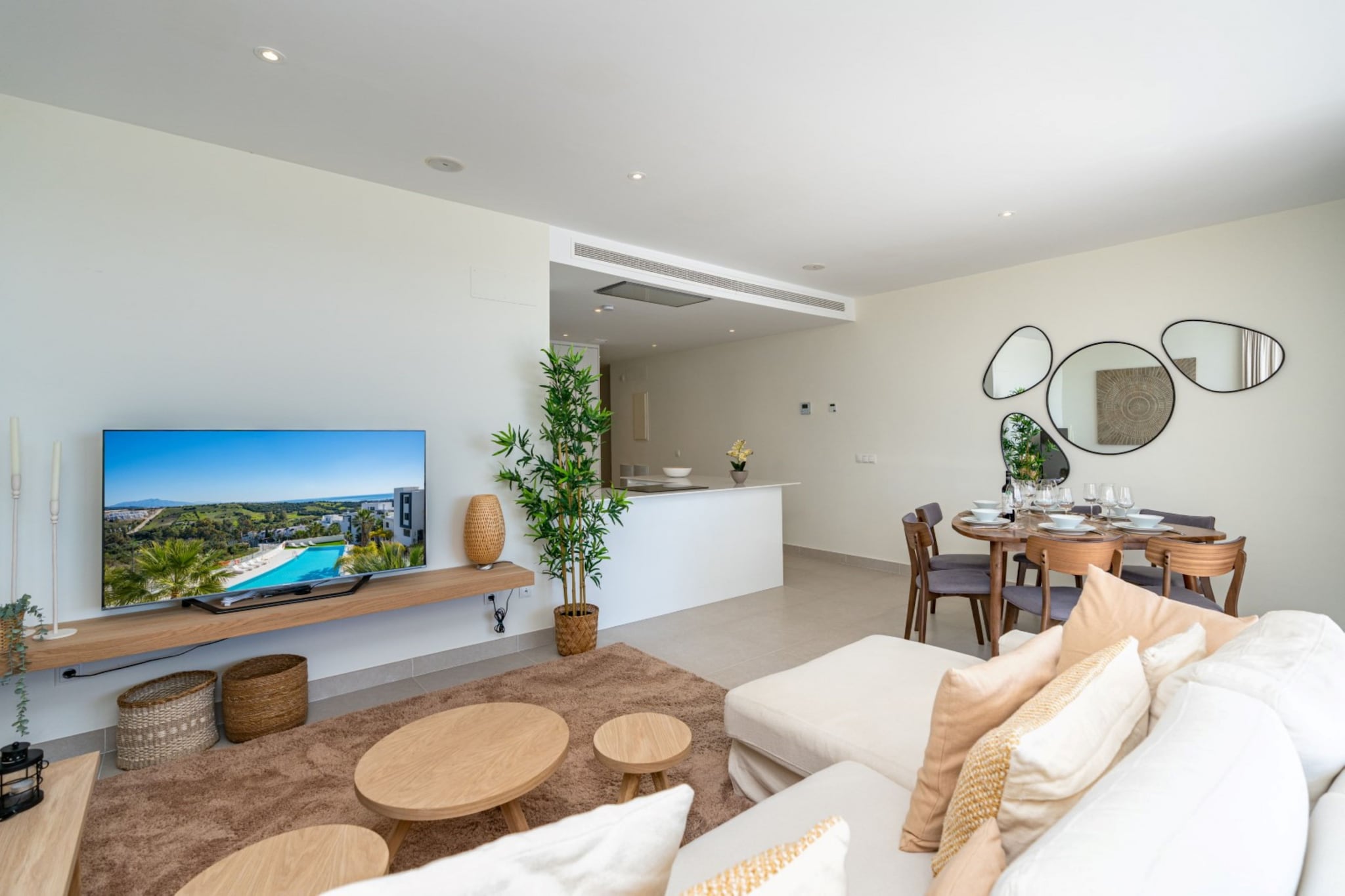 Tucked within the Mirador del Golf residence in Estepona, this modern apartment offers a relaxed base for enjoying the Costa del Sol. Surrounded by green golf landscapes and Mediterranean sunshine, the property suits families or friends looking for comfort, space and easy access to beaches and coastal towns.

Inside, the apartment accommodates up to six guests across three bedrooms. The sleeping layout includes one bedroom with a king-size double bed and two bedrooms, each with two single beds. The bright living and dining area features comfortable seating, a TV and a dining table for shared meals. A well-equipped kitchen allows convenient meal preparation during your stay. The apartment includes two bathrooms with showers and toilets, while WiFi, air conditioning, heating, elevator access and a washing machine add everyday convenience.

Step outside to the private balcony and terrace furnished with garden seating, creating a pleasant space to relax in the warm Costa del Sol climate. Guests also enjoy access to the residence's shared swimming pool and fitness room. Parking is available at the property for added convenience.

The apartment is located close to Estepona's golf courses and within easy driving distance of the town's sandy beaches and lively marina. Estepona's charming old town offers restaurants, cafés and boutique shops, making this a great base for exploring the Costa del Sol lifestyle.