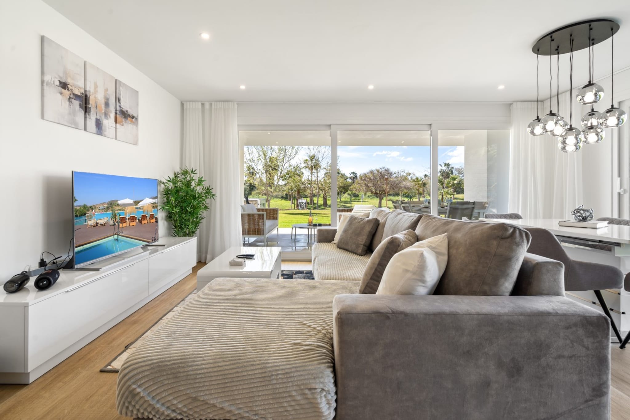 Discover relaxed resort living at this chic ground-floor apartment set within the popular Alcazaba Lagoon community in Casares near Estepona. Surrounded by landscaped gardens and modern Mediterranean architecture, the residence offers a comfortable base for families or friends looking to enjoy the Costa del Sol lifestyle.

Inside, the apartment accommodates up to six guests across three bedrooms, including two bedrooms with king-size double beds and one bedroom with a queen bed. The bright living and dining area features comfortable seating, a Smart TV, a radio and a dining table for shared meals. A well-equipped kitchen supports everyday cooking during your stay. Two bathrooms with showers, washbasins and toilets add convenience, while internet access, heating, elevator access and a washing machine provide everyday comfort.

Step outside to enjoy the private terrace and garden area, where outdoor seating and sun loungers create a relaxing place to unwind. Guests also have access to the resort's shared amenities, including a swimming pool, a children's pool, landscaped gardens, and wellness facilities such as a fitness room, sauna, and two wooden hot tubs. Parking is available within the complex.

Alcazaba Lagoon is known for its turquoise lagoon and relaxed resort atmosphere. The beaches, marina and charming old town of Estepona are a short drive away, offering restaurants, boutiques and seaside promenades along the Costa del Sol.