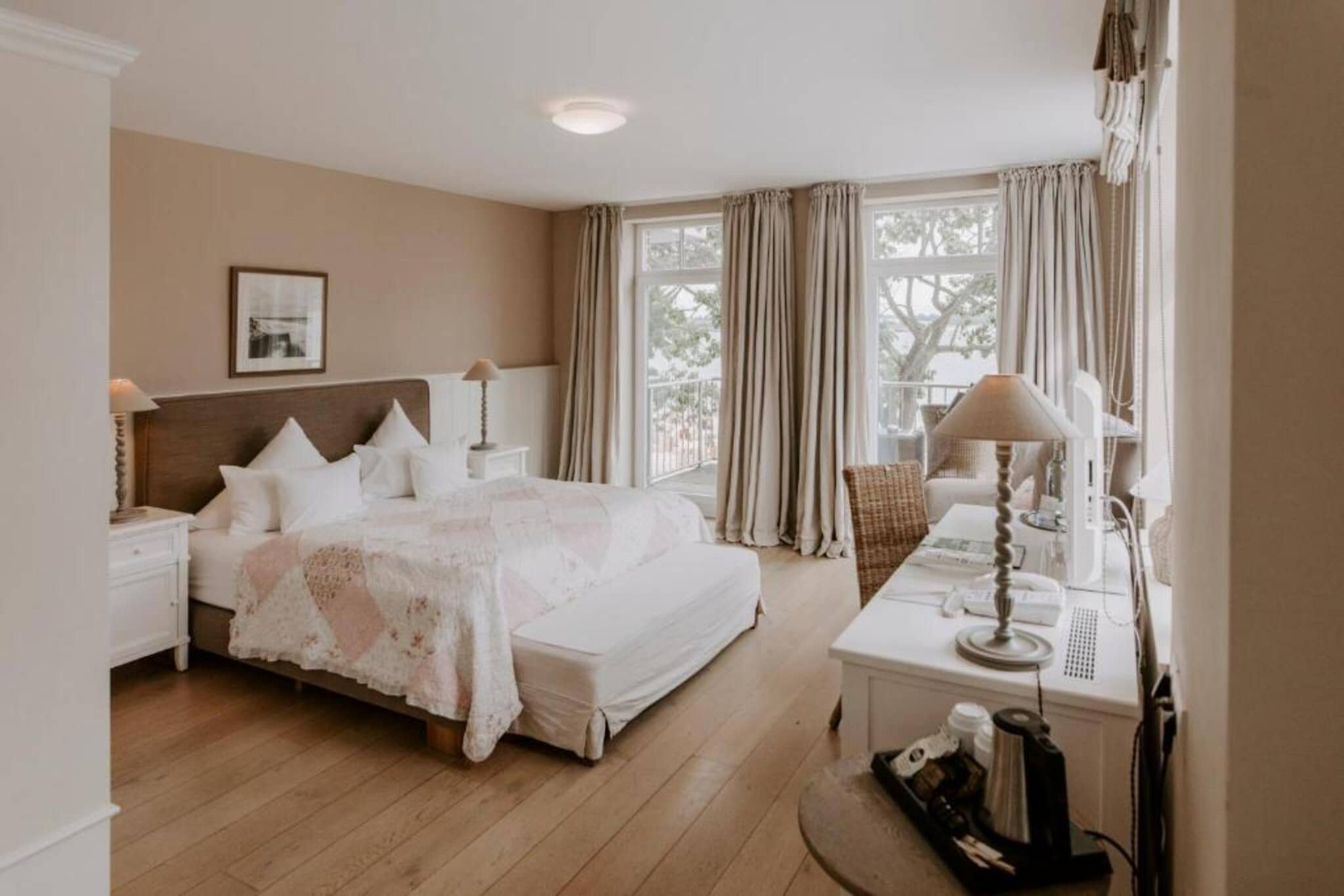 Positioned at a prime corner location of the hotel, the 43 m² Corner Junior Suite Sea Side Adults Only offers panoramic Baltic Sea and lake views from its private balcony. Designed for couples who appreciate space, light and coastal elegance, this refined suite combines modern comfort with a peaceful seaside atmosphere. The stylish interiors, generous layout and soundproofed design create a relaxing retreat directly on the shores of the Kiel Fjord.

Room Amenities

1. 43 m² elegant corner junior suite with enhanced views.
2. Extra-large double bed with high comfort rating.
3. Private balcony overlooking the sea and lake.
4. Soundproofed interiors for restful sleep.
5. Flat-screen TV with cable channels, radio and telephone.
6. Minibar and electric kettle.
7. Desk and comfortable seating area.
8. Safety deposit box and wardrobe.
9. Private bathroom with bath, shower, bathrobes, slippers and hairdryer.
10. Complimentary toiletries, towels and free WiFi.

Hotel Amenities & Services

1. Direct beachfront location on the Baltic Sea.
2. Sauna and wellness facilities for relaxation.
3. On-site restaurant and breakfast service.
4. Lift access and non-smoking rooms.
5. Allergy-friendly room options.
6. Free WiFi in public areas.
7. Parking available for 10 euros per night payable on-site

Nearby Attractions

1. Kiel city centre – approx. 10 km.
2. Naval Memorial Laboe – approx. 5 km.
3. Kiel Fjord promenade – walking distance.
4. Baltic Sea beaches – direct access.

How to Reach

1. Kiel Central Station – approx. 10 km.
2. Hamburg Airport – approx. 100 km.
3. Easily accessible by car.

The Corner Junior Suite Sea Side Adults Only offers refined coastal comfort, breathtaking views and a serene Baltic Sea setting for an unforgettable stay in Heikendorf.
