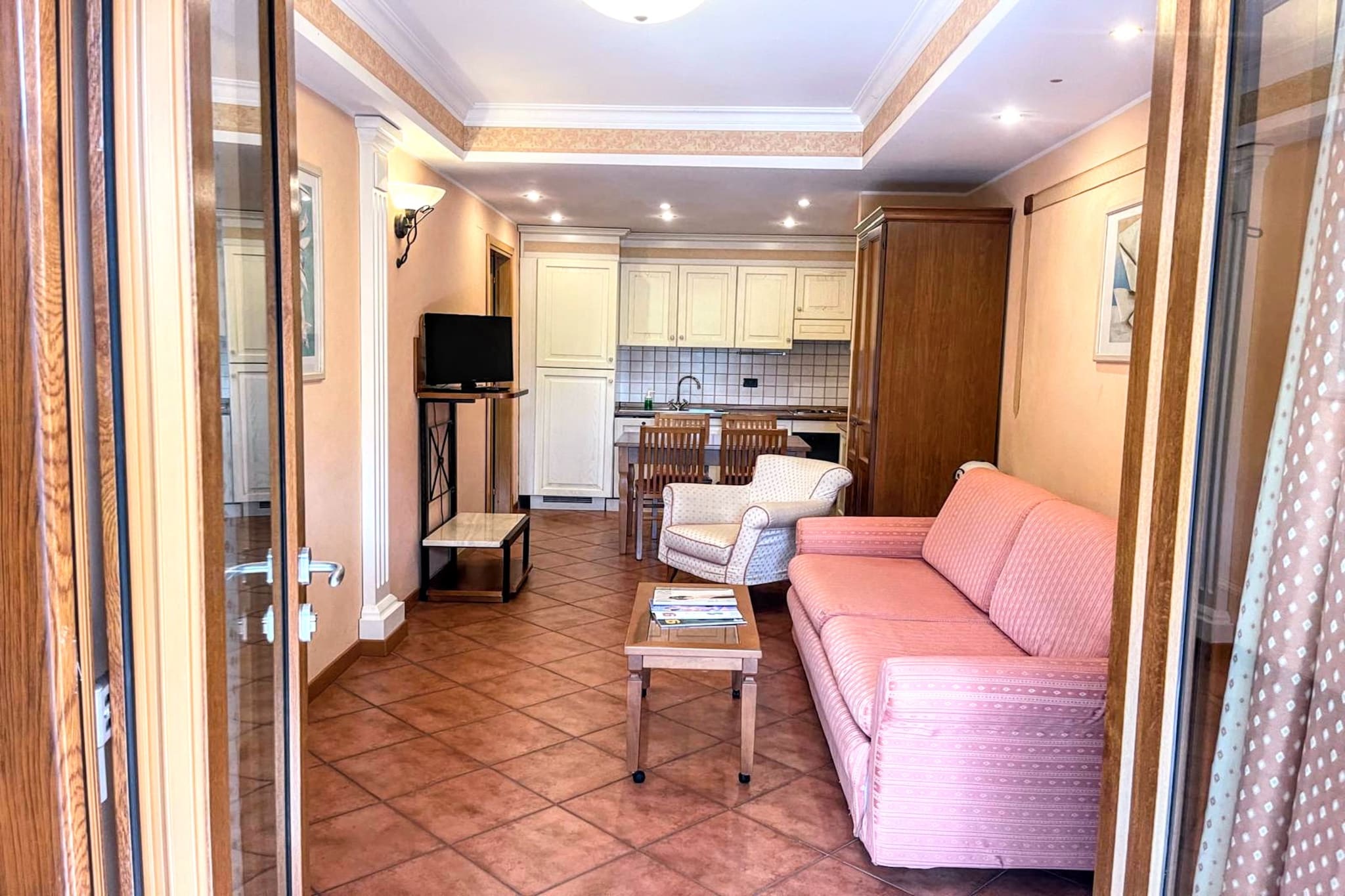 Situated within an elegant residence near the renowned Marco Simone golf course, this apartment offers a peaceful retreat with modern comforts. Designed for relaxation, the accommodation includes cozy beds, air conditioning, and stylish furnishings. Guests enjoy hotel-like services with daily tidying and linen changes twice a week. The residence features a breakfast room, an on-site restaurant, and covered parking, ensuring a stress-free stay. Located just 20 km from Rome's vibrant city center, the property provides a shuttle service to the Rebibbia metro stop, making it easy to explore historic landmarks, charming cafes, and bustling markets. A variety of excursions are available, offering guests the chance to discover Rome's rich cultural heritage. For those seeking relaxation, the famous Tivoli thermal baths, located less than 10 km away, offer the perfect escape with rejuvenating spa treatments. The apartment includes a well-equipped kitchen, allowing guests to prepare meals with ease. A comfortable living area provides space to unwind, while the modern washroom features a walk-in shower and complimentary toiletries. Golf enthusiasts benefit from an exclusive 15 percent discount at the Marco Simone golf course. Whether for leisure or exploration, this accommodation offers a serene yet well-connected getaway.