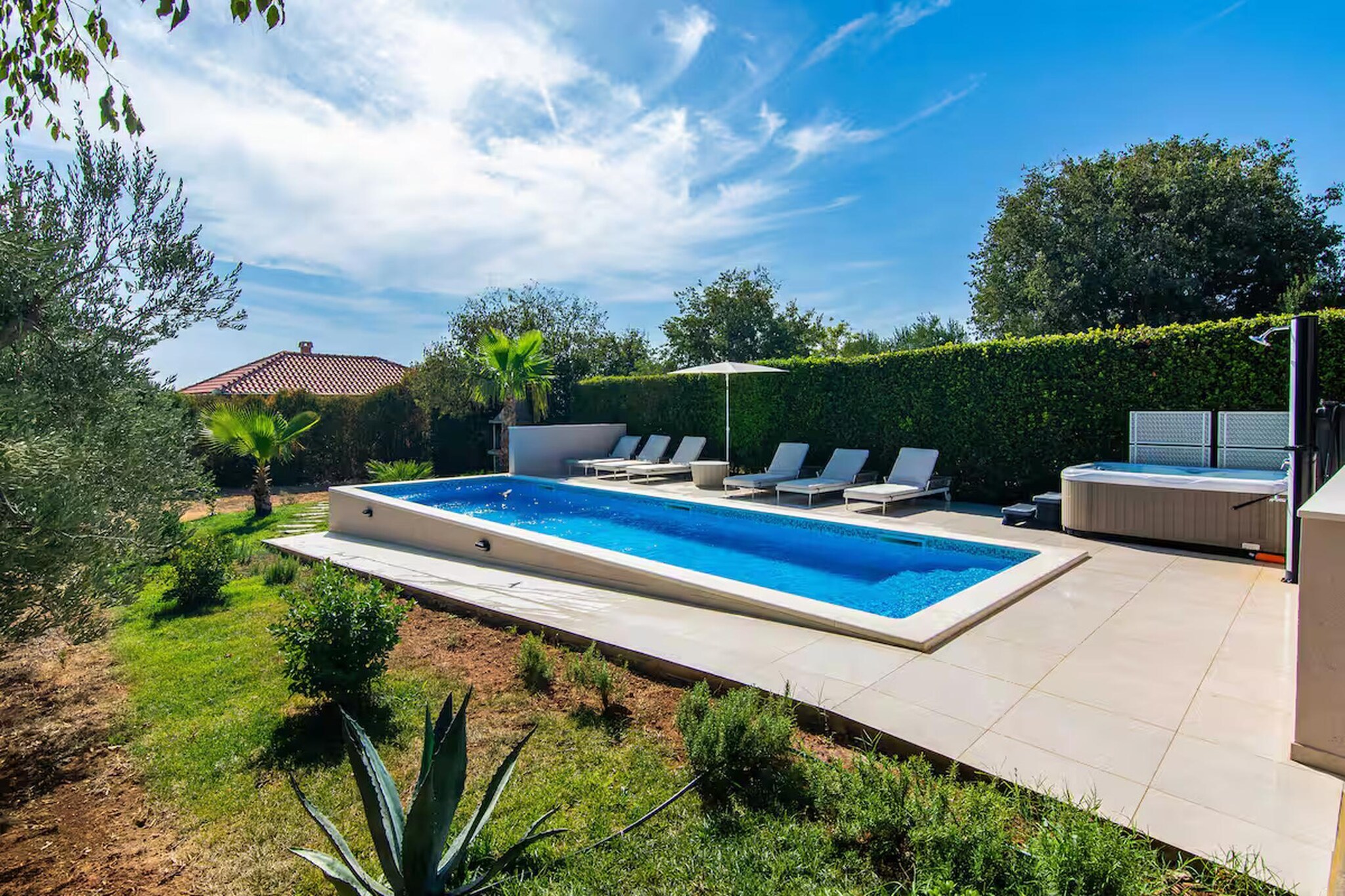 Surrounded by olive groves and open Mediterranean landscapes, this spacious private villa in Zemunik Gornji offers a peaceful countryside retreat for up to ten guests seeking relaxation and privacy in the Dalmatian region. Ideal for families or groups travelling together, the property combines modern indoor comfort with generous outdoor living space while remaining within convenient driving distance of the Adriatic coastline and nearby historic towns.

Inside, the villa features four separate bedrooms arranged to accommodate flexible group sleeping arrangements, including three bedrooms furnished with queen-size beds and an additional bedroom with two single beds. The bright open-plan living area offers comfortable sofa bed seating and a TV for relaxed evenings indoors following time spent outdoors. A fully equipped kitchen with essential cookware, allowing guests to prepare meals with ease throughout their stay. Two fully modern bathrooms support everyday convenience, while WiFi, AC, laundry facility and a dedicated workspace provide additional practicality for longer visits.

Guests can enjoy a spacious private terrace overlooking the landscaped garden and pool area, offering an ideal setting for shared meals or quiet downtime in the fresh coastal air. A private swimming pool, whirlpool, sauna and on-site fitness room allow guests to unwind throughout the day, while recreational facilities such as billiards, darts and table football provide indoor entertainment options for group stays.

Located within easy driving distance of Zadar’s beaches, marinas and cultural landmarks, this villa offers year-round opportunities for coastal excursions, nature walks and exploring Croatia’s scenic Dalmatian countryside.