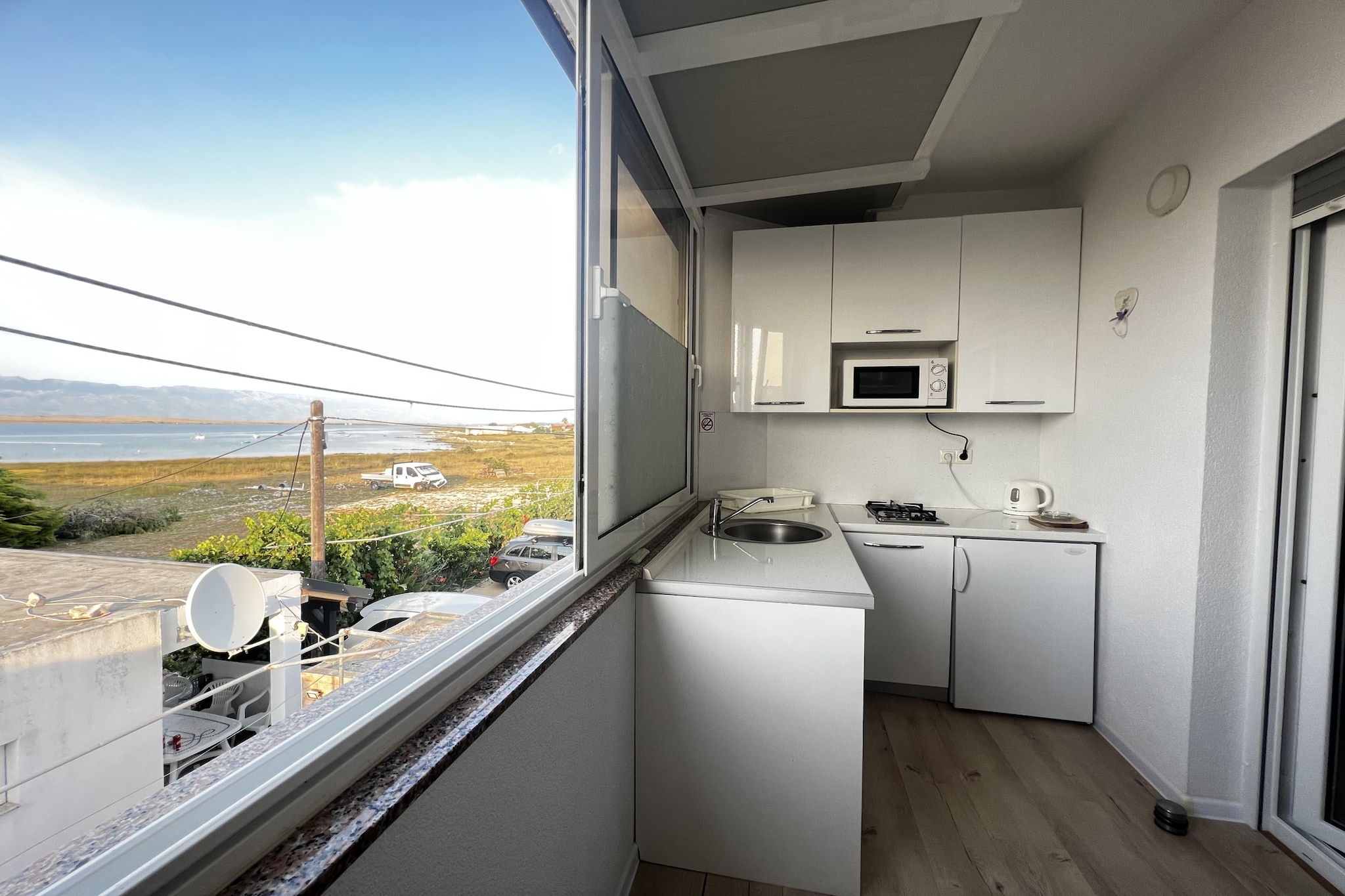 Living room(TV(flatscreen, satellite), dining table, seating area), Kitchen(hob(electric), electric kettle, toaster, coffee machine, microwave, fridge-freezer, dishes and cutlery, Cooking basics), bedroom(double bed), bathroom(shower, washbasin, toilet, hairdryer), Internet access, Garden Furniture , grill, cot, heating(electric), air conditioning, terrace, garden, BBQ, parking, high chair, iron