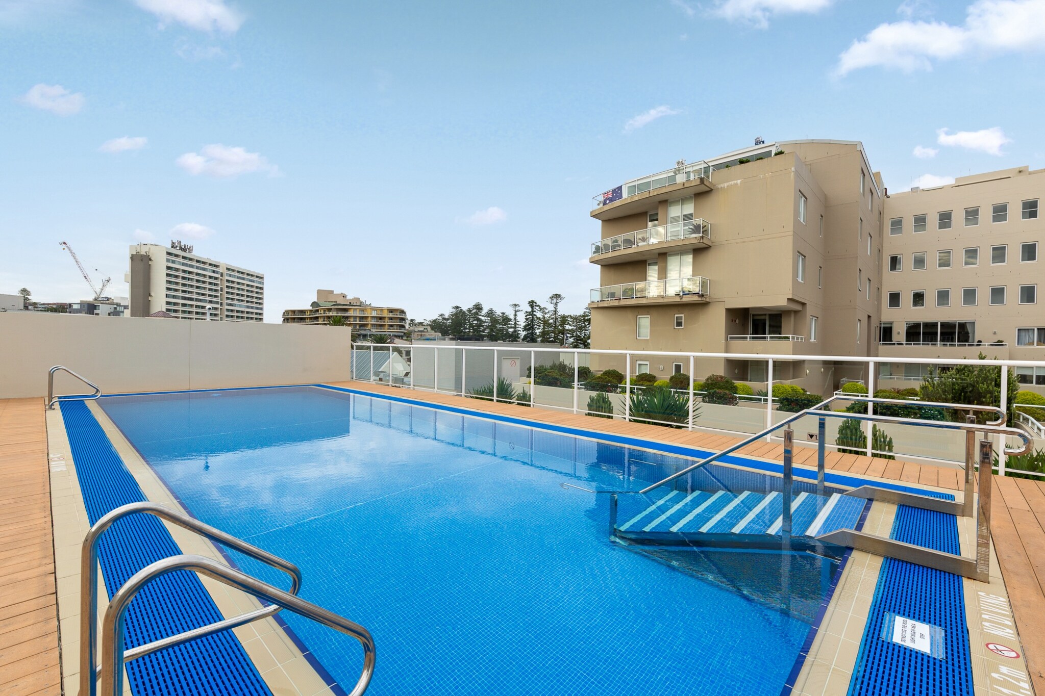 Property description
Just moments from Manly Beach, this bright and spacious 1-bedroom apartment offers relaxed coastal living with a private balcony with BBQ and fantastic building amenities including a rooftop pool and gym facilities. Enjoy ducted air conditioning throughout, a dedicated workspace and a well-equipped kitchen. Ideal for couples or business travellers, the apartment combines comfort and convenience in a prime seaside location.
The space
This welcoming apartment blends coastal charm with everyday comfort. The open-plan living area features warm wooden flooring and generous natural light, creating an inviting atmosphere to relax after a day by the beach. A three-seater sofa and coffee table provide a comfortable setting for unwinding, while the television offers free-to-air and streaming options for quiet evenings in.
 
Adjacent to the lounge, a dining table with seating for four makes mealtimes easy and sociable. The kitchen is thoughtfully laid out and equipped with a gas cooktop, electric oven, dishwasher and coffee machine, offering everything needed for convenient home cooking.
 
The bedroom features a queen bed with soft furnishings, bedside tables and a lamp for added comfort. Blackout blinds ensure restful sleep, while air conditioning, heating and a fan provide year-round climate control.
 
The bathroom includes a shower, vanity storage and internal laundry facilities with both a washer and dryer for added practicality. Step out from the living room onto the private balcony, complete with outdoor furniture and a BBQ, perfect for enjoying fresh sea air. Enjoy the building facilities! During your stay, you will have access to the rooftop pool, and gym facilities.