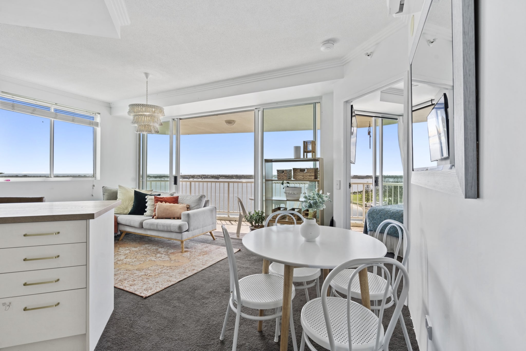 Property description
Soak up the sunshine and ocean breeze from this cosy 2-bedroom apartment in Labrador. Enjoy open-plan living, a full kitchen, and sweeping views from the private balcony. With access to a pool, gym, and sauna, this apartment offers a relaxing beachside escape just steps from the Broadwater and local cafés.
The space
Step into a welcoming and light-filled space where ocean views and comfort combine. The open-plan living and dining area features a stylish sofa, natural plants, eclectic décor, and a wall-mounted TV. A dining table for four and three breakfast bar stools make mealtime a breeze.
 
The kitchen is well-equipped with an induction cooktop, oven, microwave, toaster, kettle, fridge, and dishwasher. Ample cookware, cutlery, and glassware are provided for home-style cooking.
 
Two serene bedrooms offer a king and queen bed, both styled with cushions, throw blankets, bedside tables, and lamps. Large windows bring in the sea breeze and natural light, while soft linens and mattress protectors ensure restful nights.
 
The bathroom includes a walk-in shower, modern vanity, and hairdryer. A private laundry with a washer and drying rack provides added convenience.
 
Enjoy coffee or dinner on the private balcony with outdoor seating, overlooking the stunning Broadwater. Additional access to the building’s pool, gym, and sauna enhances your beachside lifestyle.
 
With a bright, coastal feel and all the essentials, this apartment offers a relaxing stay close to Labrador’s waterfront attractions.