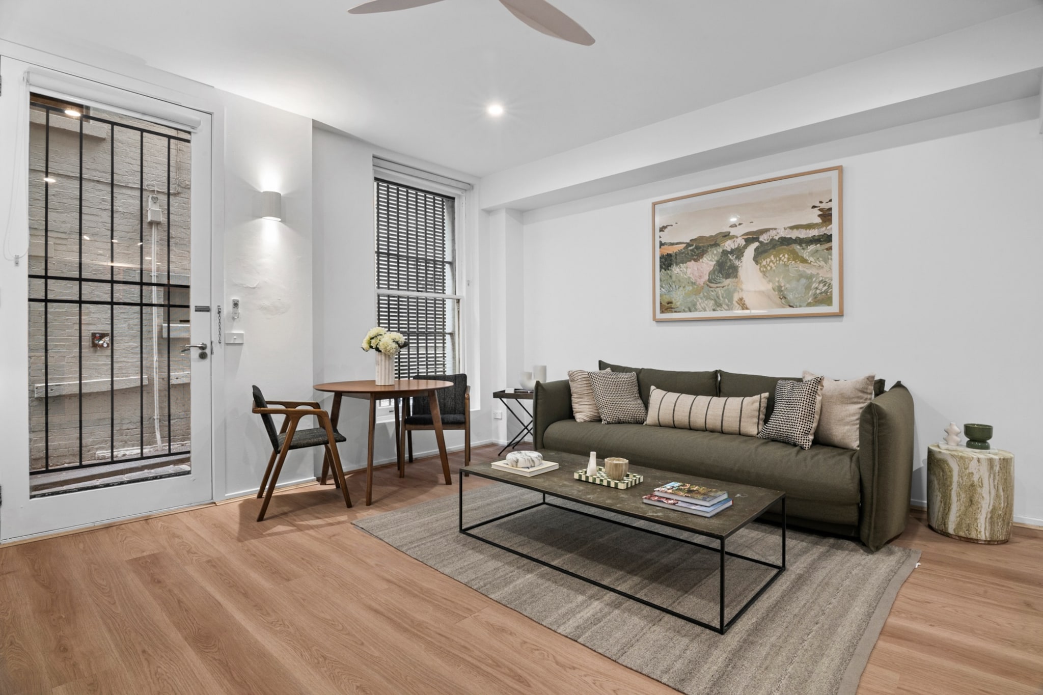 Property description
Tucked within one of Melbourne’s iconic laneways, this heritage apartment offers a charming CBD stay in a historic 1880s building. Enjoy seamless self check-in via lockbox and step straight into the city’s vibrant café, dining and cultural scene. Ideal for couples or business travellers seeking character, comfort and a truly central base.
The space
Step inside and discover a thoughtfully arranged apartment blending heritage character with contemporary comfort. Timber flooring flows throughout, adding warmth to the light-filled interiors.
 
The living area is styled with decorative touches and artificial greenery, creating a welcoming place to relax. A comfortable three-seater sofa easily converts into a sofa bed, offering additional sleeping space when required. A TV and coffee table complete the setting, while a dining table with seating for two provides an intimate space for meals or work.
 
The bedroom features a queen bed dressed for comfort, accompanied by two bedside tables and matching lamps for soft evening lighting. A fan ensures airflow, enhancing comfort year-round.
 
The bathroom is neatly presented and well-maintained, complete with a shower, toilet and vanity. Storage cupboards are empty and ready for guest use.
 
A private laundry with a washer and dryer adds convenience, making longer stays effortless.