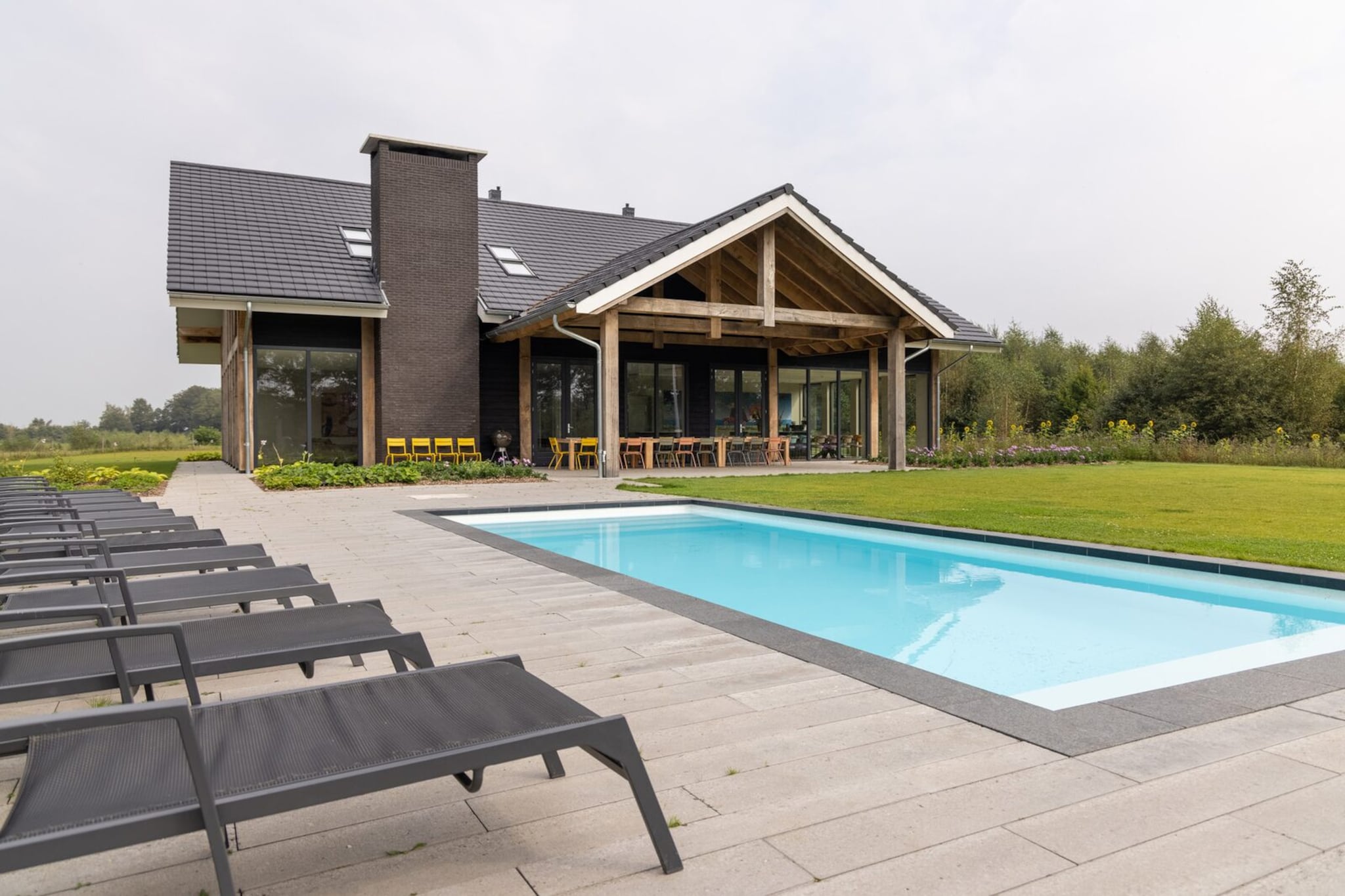Discover the perfect blend of modern luxury and natural serenity in this stunning holiday villa, situated in the heart of the Achterhoek near Aalten. Recently constructed and designed to bring the outdoors in, the villa features expansive windows that frame the tranquil landscape of rolling meadows, ancient trees, and winding streams. The interior is a masterpiece of comfort and style, boasting a spacious living room with a cozy fireplace, an Xbox for entertainment, and a professional-grade kitchen equipped with a steam oven, dual dishwashers, and a Quooker. With ten comfortable bedrooms—all featuring high-quality box spring beds—and nine modern bathrooms, the home provides an elegant and private sanctuary for large groups looking to unwind in style.

Wellness and active play are at the center of the experience here. Guests can rejuvenate in the private Finnish sauna, maintain their fitness routine in the dedicated wellness area, or enjoy a game of foosball in the recreation space. Outside, the fully fenced garden is a playground for all ages, featuring a climbing frame, swings, and a trampoline. The highlight of the outdoor space is undoubtedly the heated swimming pool, available from April through September, surrounded by loungers for ultimate relaxation.

The location offers endless opportunities to immerse yourself in the rich culture and lush landscapes of East Gelderland. Whether you are cycling the famous "Eight Castles" route, exploring the historic 'Book Town' of Bredevoort, or taking a cultural day trip to the German city of Münster, you are perfectly positioned to enjoy the best of the region.