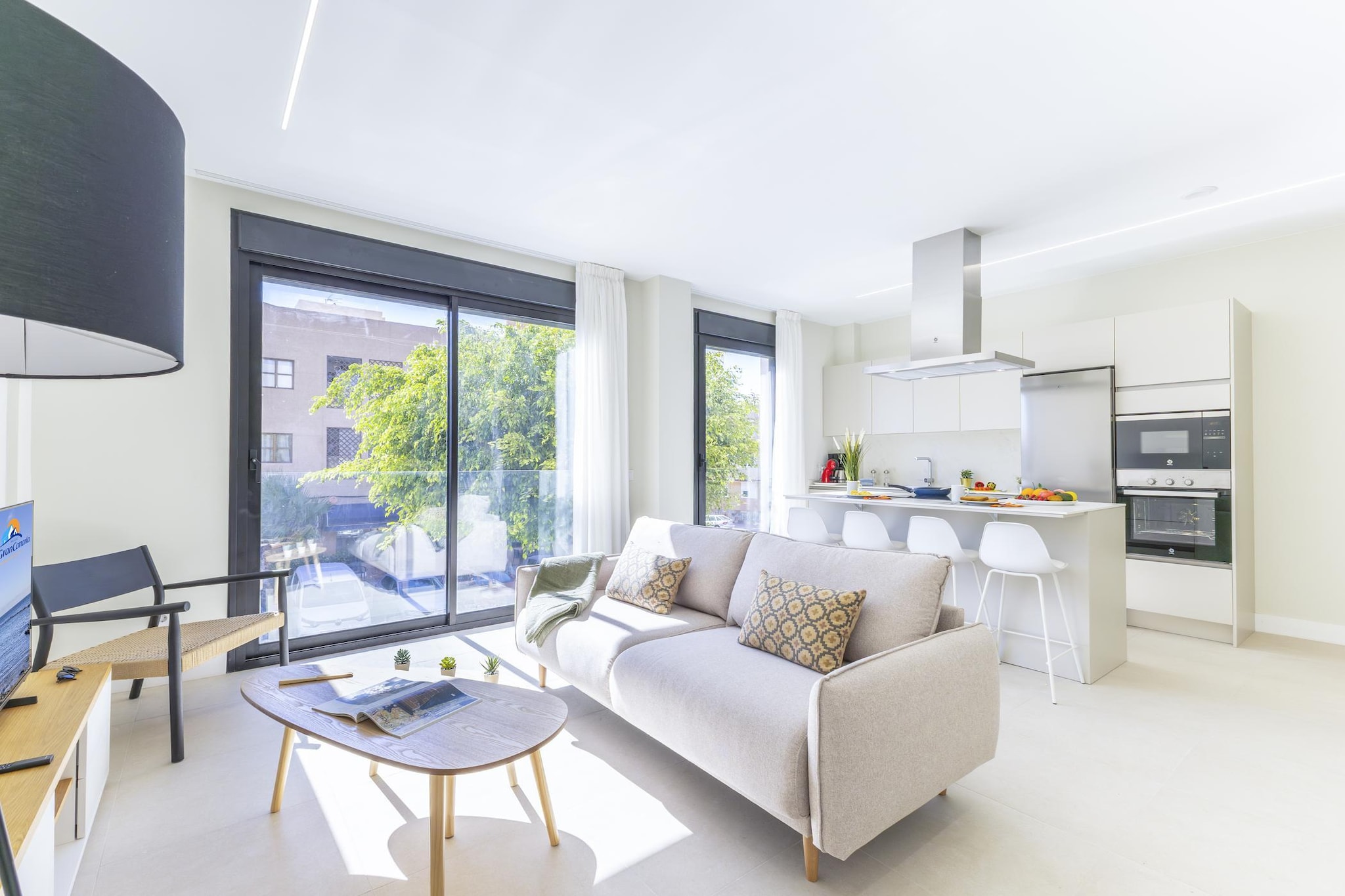 Located in the charming coastal town of Arinaga on Gran Canaria’s southeastern shore, this apartment places you moments from the seaside promenade. The area is known for its authentic atmosphere, natural swimming areas, and beautiful coastal walks, offering a relaxed way to experience island life.

Inside, the apartment accommodates up to four guests across two bedrooms - one with a double bed and the other with two single beds - making it well-suited for families or small groups. The cozy living and dining area offers comfortable seating and a Smart TV, providing a pleasant space to relax after a day by the sea. A basic-equipped kitchen includes essential appliances, making daily cooking simple. Two complete bathrooms with showers add convenience for shared stays, while air conditioning and high-speed Wi-Fi keep the space comfortable and connected. Guests also benefit from a private rooftop laundry room with an individual washing machine for added practicality during longer visits.

The building features a shared rooftop terrace with a solarium, offering a pleasant outdoor space where guests can enjoy the island sunshine. With seating and open views, it’s a relaxing spot to unwind after exploring the coastline, while the elevator ensures convenient access throughout the building.

Arinaga’s oceanfront promenade is just a short walk away and is perfect for daily strolls with sea views, morning coffee stops and easy access to local restaurants and shops. Natural swimming areas and coastal paths invite refreshing dips and relaxed exploration, while the location also makes it easy to discover other highlights across Gran Canaria.