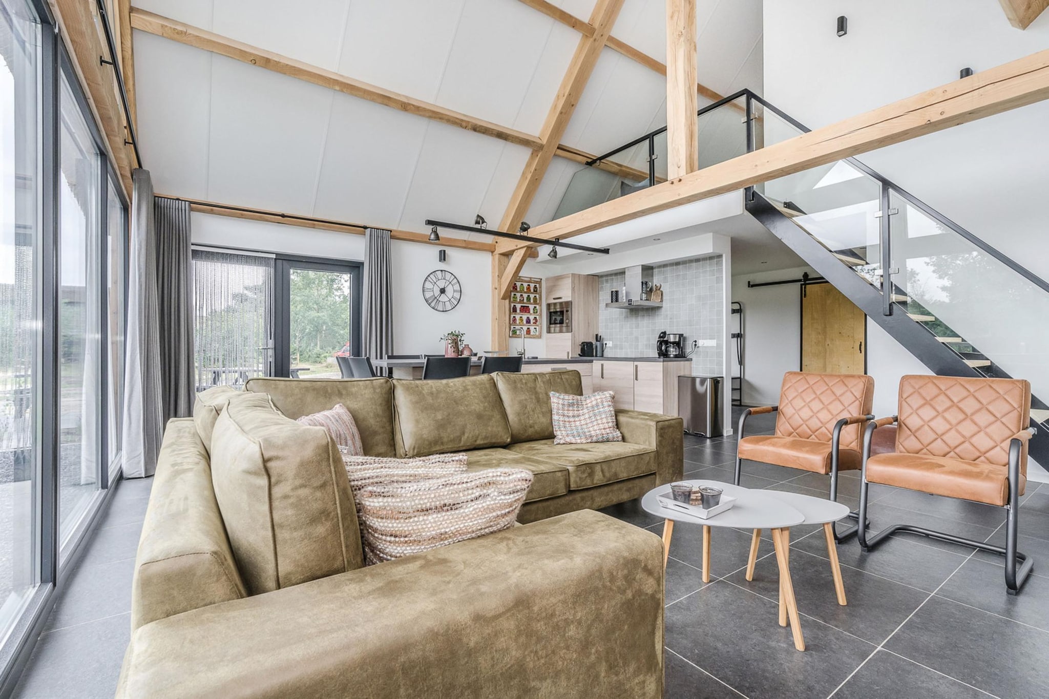 Surrounded by greenery in a quiet holiday park near Baarle-Nassau, this detached home offers a relaxed setting where space and nature shape the experience. With a practical layout across two levels and easy access to outdoor areas, it is well-suited for families or small groups looking to unwind in a calm environment.
Inside, the home features three bedrooms and accommodates up to six guests. On the ground floor, two bedrooms each include a double bed, while the first floor offers a third bedroom with a double bed and a private bathroom, creating a clear and comfortable setup for group stays. The living area is bright and well arranged, with a seating space, a TV and a dining table for shared moments. A fully equipped open kitchen includes appliances such as a coffee machine, oven, dishwasher and refrigerator, making everyday cooking simple. The property also includes two bathrooms, one with a bathtub or shower on the ground floor and a second with a shower upstairs, along with amenities such as WiFi, a washing machine and on-site parking for added convenience.
Outside, a private garden with a furnished terrace provides a pleasant space for outdoor dining or relaxing in the fresh air. The surrounding park setting adds a sense of openness, while access to a shared swimming pool offers an additional option for leisure during warmer days.
Located near Baarle-Nassau on the Dutch-Belgian border, the property is close to forests, cycling routes and unique enclave streets. Nearby towns such as Breda and Tilburg offer shopping and dining, while attractions like the Efteling theme park make it easy to plan day trips. This home provides a well-balanced base for both relaxation and exploration.
