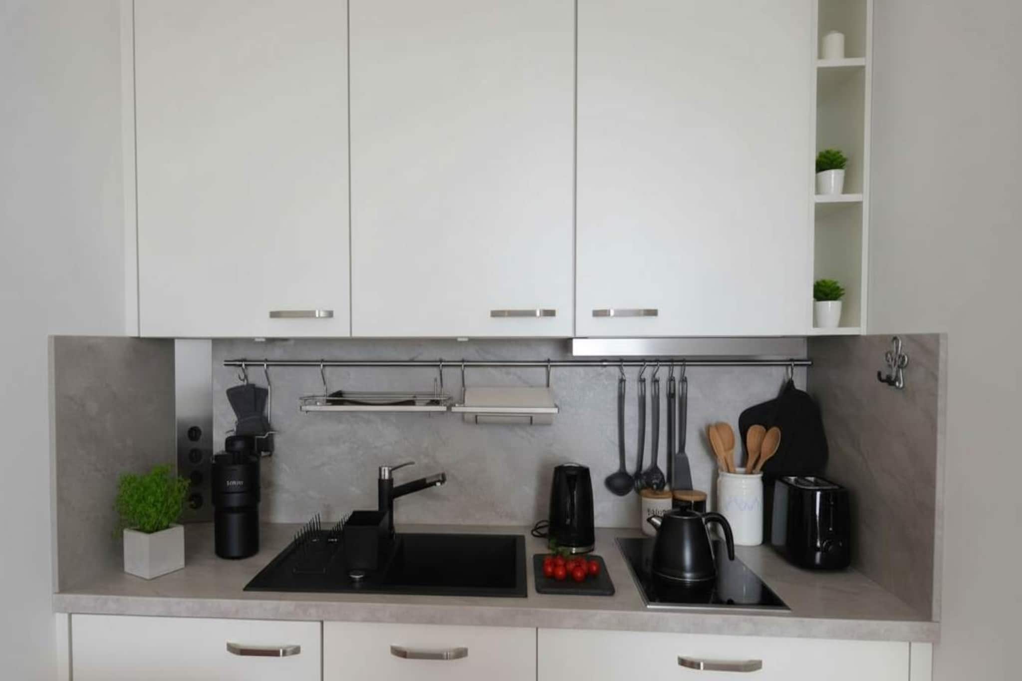 This bright and stylish studio apartment offers an exceptional urban living experience in the vibrant heart of Berlin. Perfectly situated near the iconic Alexanderplatz, the space is flooded with natural light, creating a warm and inviting atmosphere for solo travelers or couples. The studio features a thoughtfully designed layout with a comfortable bed and a modern bathroom that includes a bathtub, offering a rare opportunity for relaxation in the center of the bustling city. Located in a well-maintained building with elevator access, the apartment provides a peaceful retreat while keeping you just steps away from world-class shopping, dining, and landmarks.

The interior is fully equipped for a seamless stay, whether you are visiting for a quick city break or taking advantage of the long-term stay option. The functional kitchen comes complete with a stove, oven, and refrigerator, as well as a coffee maker, kettle, and all necessary cookware and dinnerware. To ensure a stress-free experience, the studio also includes a washer, iron, and ironing board, making it easy to manage laundry during your stay. Guests will stay connected and entertained with high-speed wireless internet and a flat-screen TV, all within a climate-controlled environment supported by a reliable heating system.

Every detail has been curated to provide the comforts of home, from fresh bed linens and towels to essential bathroom amenities like shampoo and a hair dryer. The central location offers unparalleled access to Berlin's extensive public transport network, allowing you to explore the city's diverse neighborhoods with ease.