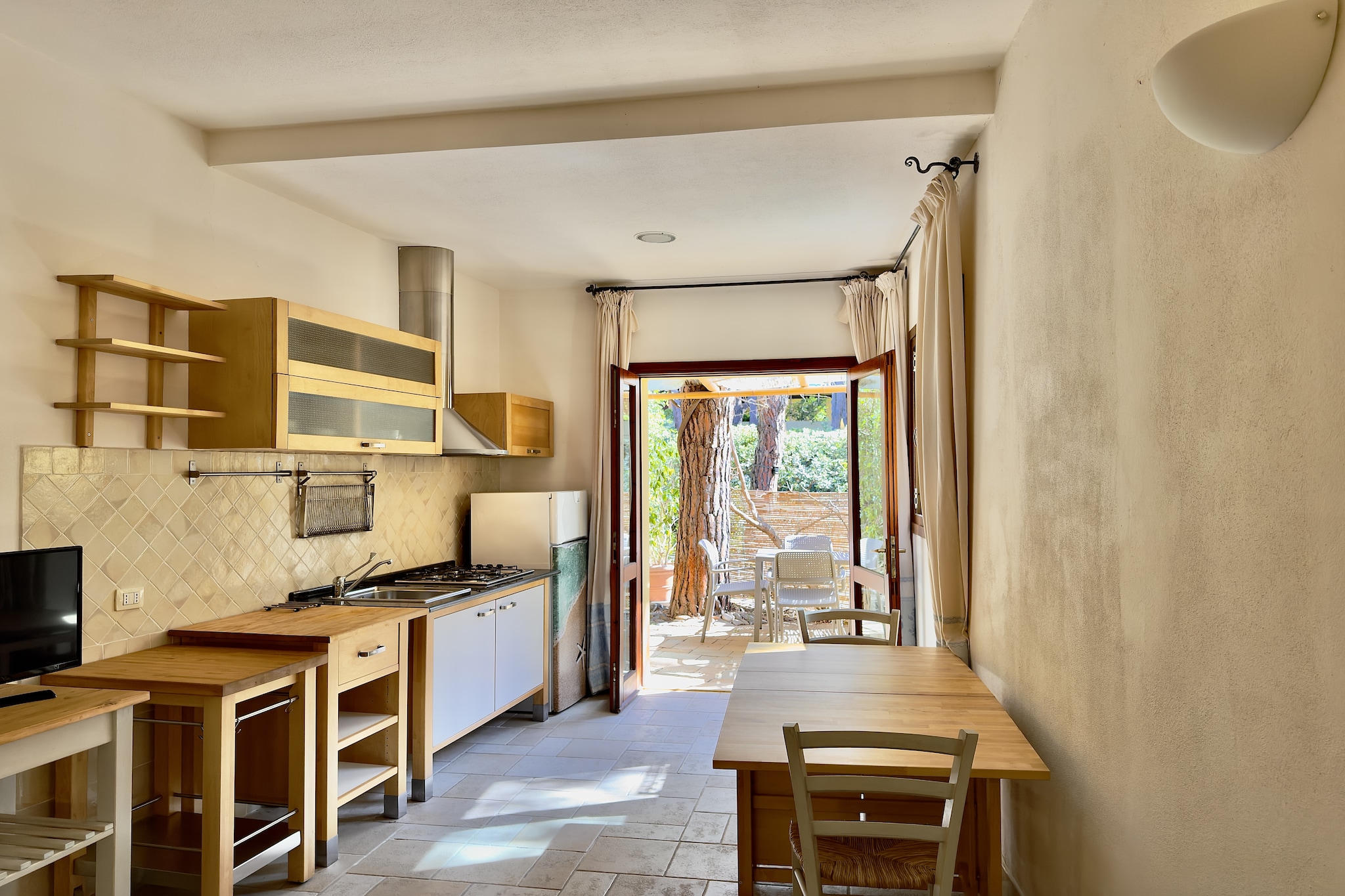 Ground floor: (Kitchenette(hob, electric kettle, toaster, fridge-freezer), Living/bed room(double bed or 2 single beds, TV, dining table, seating area), bathroom(shower, washbasin, toilet, bidet, hairdryer))\n\nReception, tumble dryer(shared with other guests), washing machine(shared with other guests), air conditioning, terrace(private), BBQ(shared with other guests), parking, parasol, swimming pool(shared with other guests, including separate children’s swimming pool (depth 50cm))