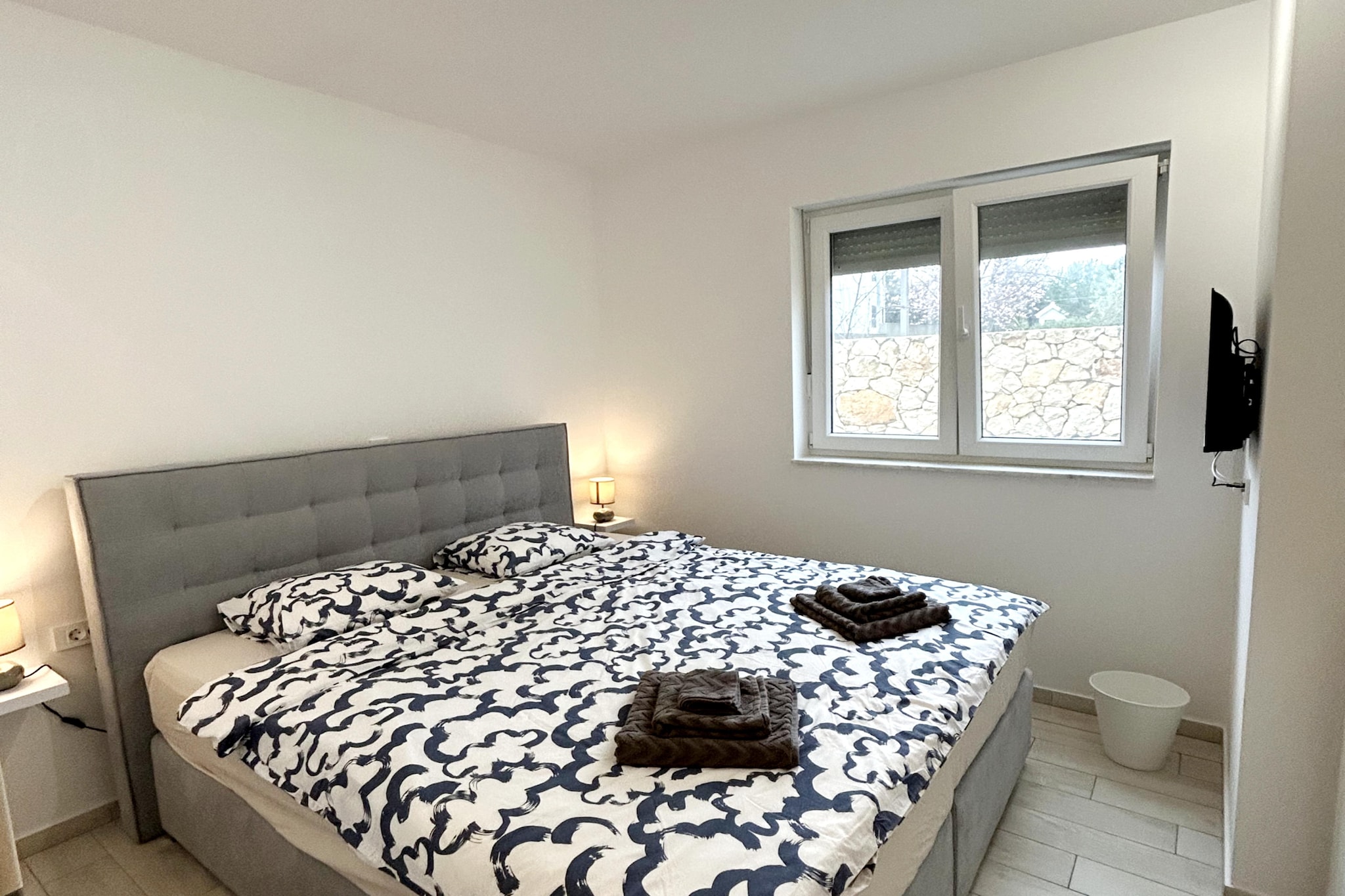 The apartment in Zaton has 2 bedrooms and capacity for 4 persons. Accommodation of 97 m² nice and is a new build. The property is located 650 m sand beach "Plaža Pliša", 650 m rock beach, 650 m the restaurant, 650 m coffee shop, 3 km city "Nin", 4 km supermarket "Supermarket Plodine", 14 km hospital "Opća bolnica Zadar", 26 km international airport "ZL Zadar", 26 km airport "ZL Zadar", 50 km nature reserve "NP Paklenica" and it is located in a a family-friendly zone and close to a shopping area and restaurants. The accommodation is equipped with the following items: garden, outdoor furniture, fenced plot, terrace, washing machine, barbecue, iron, internet (Wi-Fi), hair dryer, balcony, electric heating, air-conditioned, swimming pool communal, heated swimming pool communal, open-air parking in the same building, mosquito nets throughout the accommodation, 3 TVs. The open plan kitchen, electric, is equipped with refrigerator, microwave, oven, freezer, dishwasher, dishes/cutlery, kitchen utensils, coffee machine, toaster and kettle.