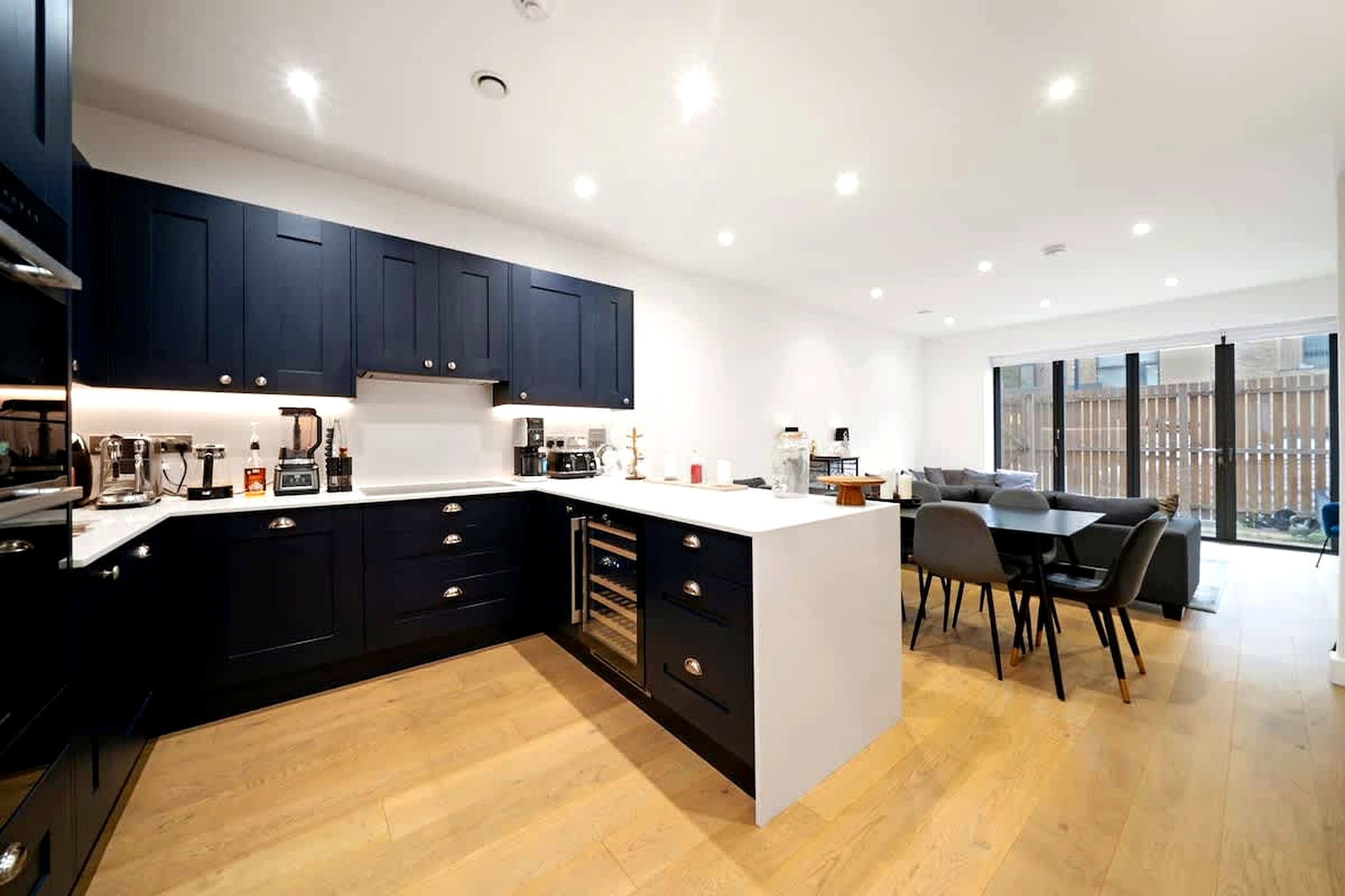 Positioned in a well-connected London neighbourhood close to Notting Hill and Hyde Park, this spacious townhouse offers a refined stay with the rare advantage of on-site parking. Designed to accommodate up to eight guests, it provides a comfortable base for families, groups, or business travellers looking to stay within easy reach of central attractions.

Inside, the home features four large double bedrooms arranged across multiple levels, offering both space and privacy for larger groups. The layout includes a bright living area with comfortable seating and a dining space, while large windows enhance the natural light throughout. A fully equipped kitchen includes essential appliances and cookware, making it suitable for extended stays. The property also includes two bathrooms plus a separate toilet, supporting convenience for group travel, along with features such as Wi-Fi, heating, and practical storage.

The townhouse extends to an outdoor patio or terrace area, providing additional space to relax. One of the standout features is the availability of private parking, a rare and valuable addition in this part of London.

Located within proximity to Notting Hill, guests can explore Portobello Road Market, local cafés, and boutique shops, while Hyde Park offers open green spaces for walking and leisure. Excellent transport links nearby provide easy connections to central London, including areas such as Covent Garden and Westfield shopping centre. With its spacious design, prime location, and added convenience of parking, this townhouse is ideal for a well-connected city stay.