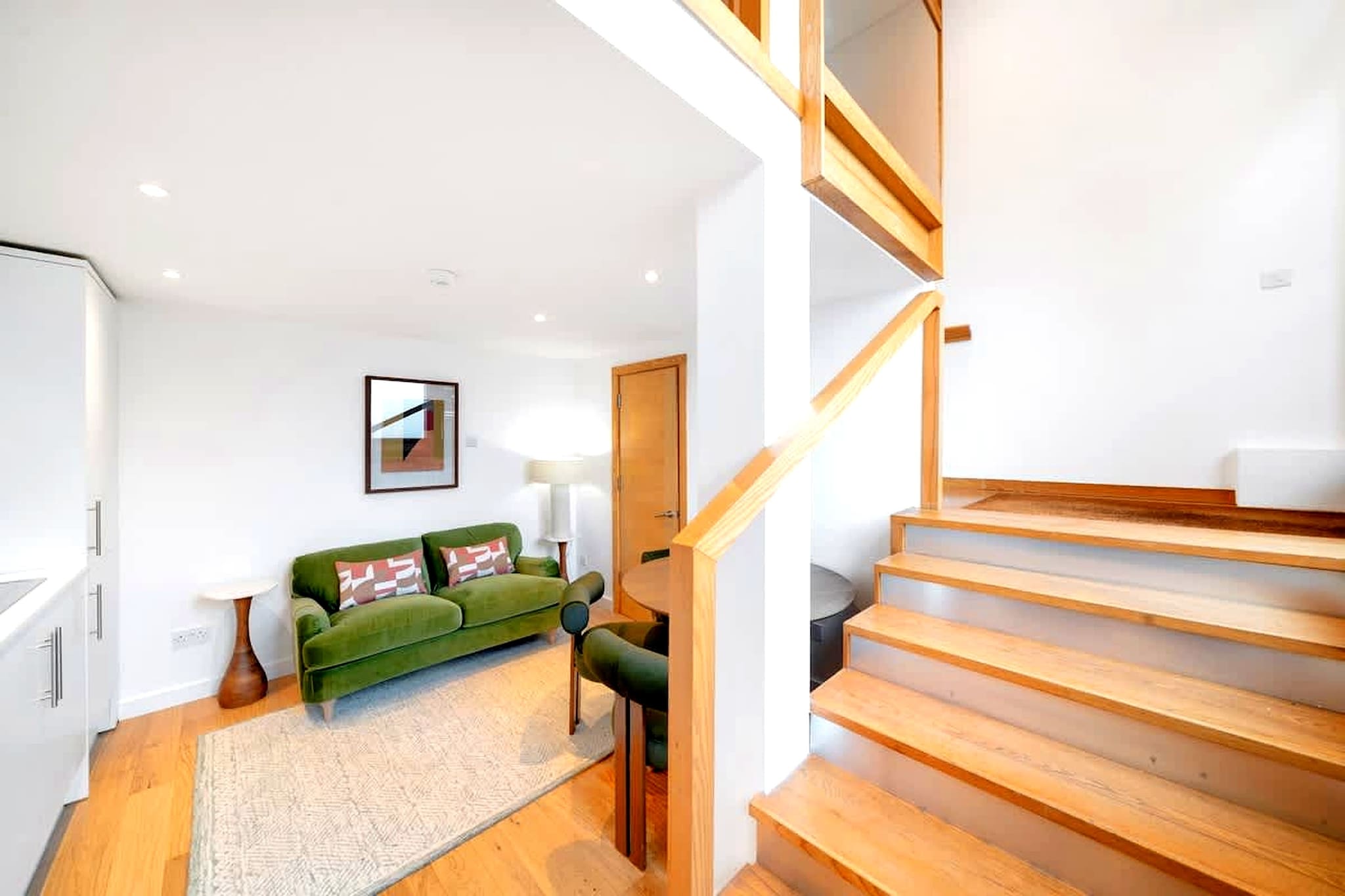 Designed across two levels, this modern Fulham apartment offers a unique stay with a layout that adds both character and separation of space. Located on Dawes Road, it places you in one of London’s most vibrant neighbourhoods, with cafés, restaurants, and excellent transport connections all within easy reach.

The lower level features an open-plan living and kitchen area, arranged with cozy seating, a TV, and a dining setup that works well for both relaxing and casual meals. The kitchen is fully equipped with a stove, oven, microwave, and dishwasher, supporting convenient self-catering. Upstairs, the mezzanine-style bedroom includes a double bed and an additional TV, creating a more private sleeping area away from the main living space. A bathroom with a shower and toilet completes the layout.

The split-level design naturally separates living and sleeping areas, making the apartment feel more spacious and functional than a typical one-bedroom layout. Additional amenities such as Wi-Fi, heating, a wardrobe, washing machine, and tumble dryer ensure comfort for both short and extended stays, while paid parking nearby adds flexibility for guests travelling by car.

Located in Fulham, the apartment benefits from strong transport links, allowing quick access to central London and major attractions. The surrounding area offers a lively mix of local cafés, shops, and everyday conveniences. With its distinctive layout and well-connected location, this apartment is ideal for a comfortable and practical city stay.