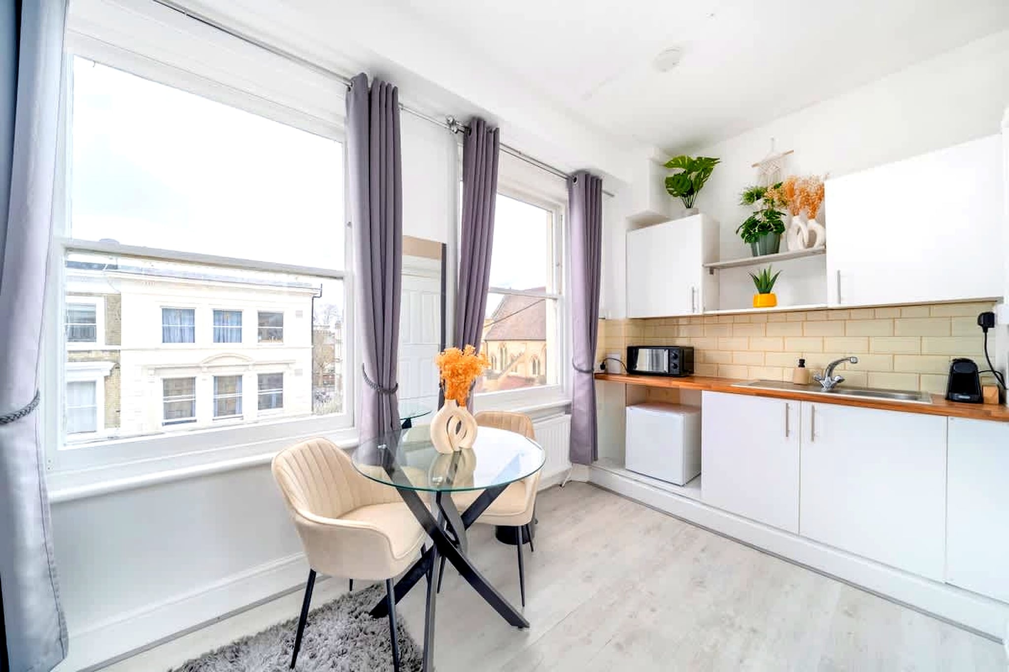 Perfect for a well-connected London stay, this modern apartment offers a compact and efficient layout just a short walk from West Kensington Underground Station. Ideal for solo travellers or couples, it provides quick access to central London while being surrounded by the lively neighbourhoods of Kensington, Fulham, and Chelsea.

Inside, the space is thoughtfully arranged to combine living, dining, and sleeping areas into one cohesive layout. A comfortable double bed sits alongside a dining table and TV, creating a practical environment for both relaxation and everyday use. The kitchenette is equipped with a coffee machine, fridge-freezer, microwave, and dishwasher, allowing for convenient self-catering despite the compact setup. A private bathroom includes a shower, toilet, and hairdryer, while Wi-Fi, heating, and essential amenities ensure a smooth and comfortable stay.

The apartment is designed for simplicity and ease, making it a suitable choice for shorter stays or city breaks. Its efficient layout allows guests to make the most of the available space without compromising on key conveniences.

Located within a 3-minute walk of West Kensington Station, the apartment offers excellent transport links across London. Nearby areas such as Kensington, Fulham, and Chelsea provide a wide range of cafés, restaurants, and shops. With its practical design and strong location, this apartment is ideal for a convenient and well-connected city stay.