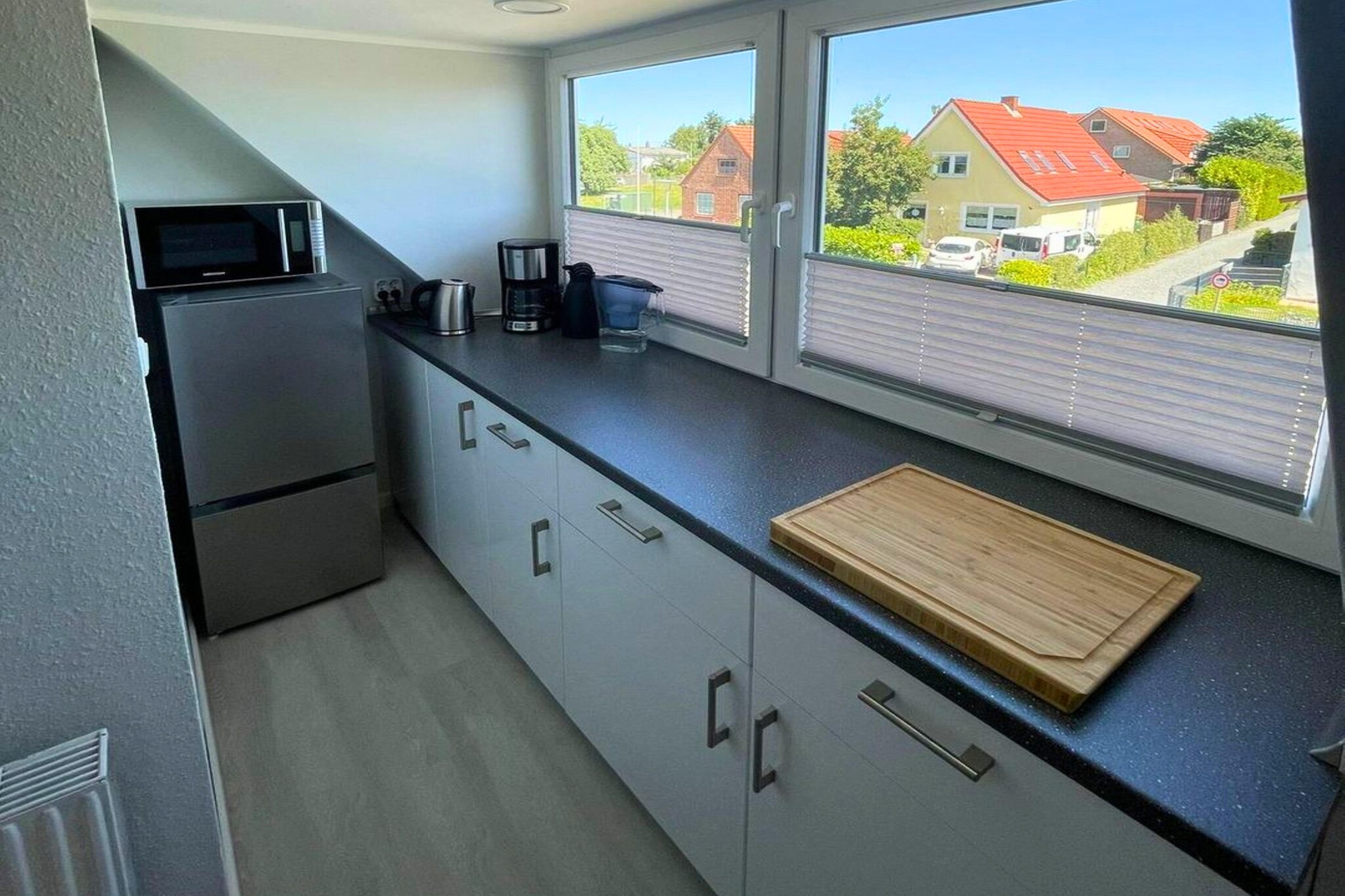 Attic: (Kitchen(electric kettle, toaster, cooker, coffee machine, oven, microwave, dishwasher, fridge-freezer), Living/diningroom(TV, dining table, seating area), bedroom(double bed), bedroom(single bed), bathroom(shower, washbasin, toilet, hairdryer))\n\ngarden, garden furniture, BBQ, parking