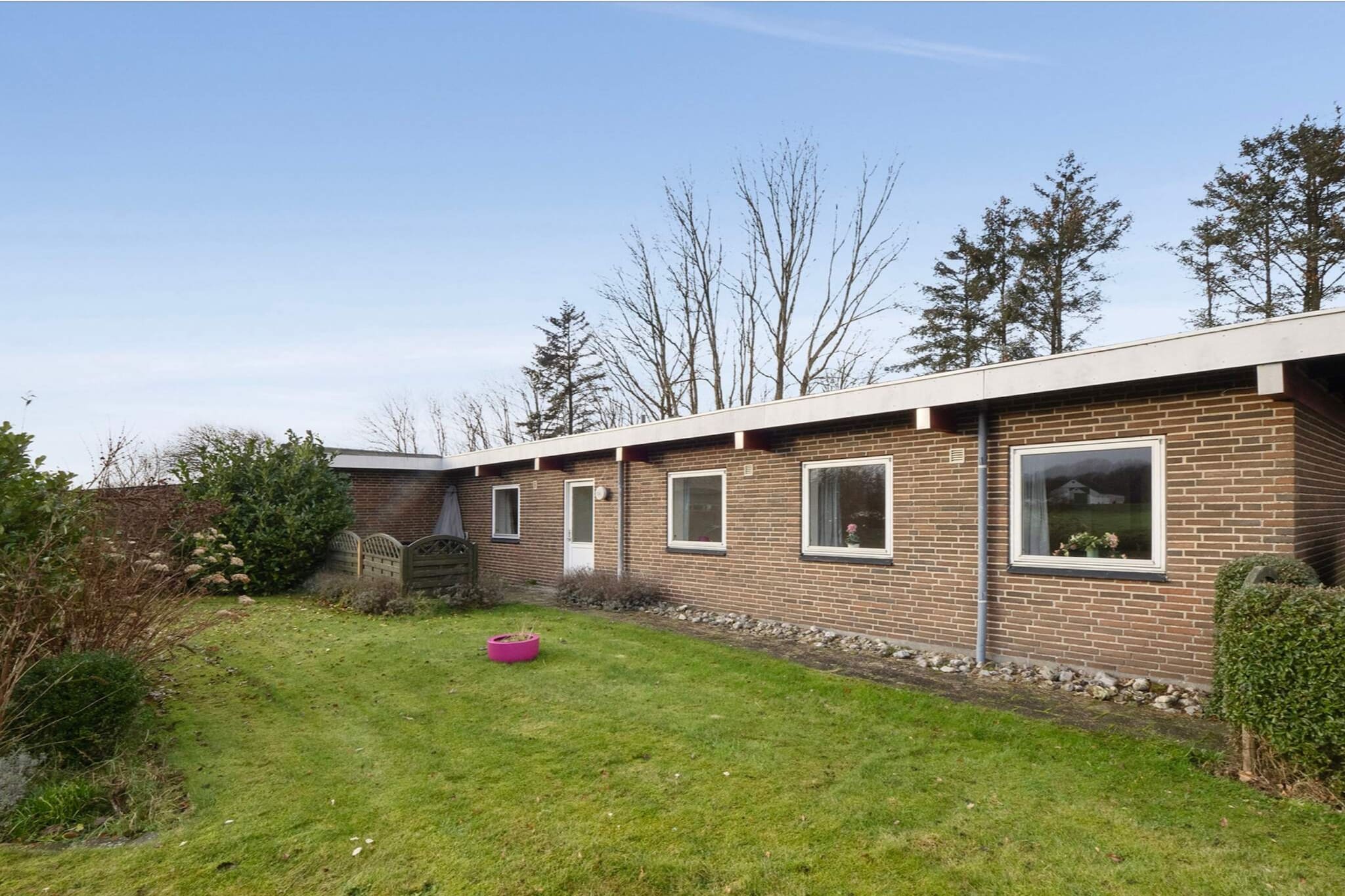 Spacious and inviting holiday home in scenic surroundings Here, a holiday awaits you with plenty of space, tranquility, and views of open fields. The house is peacefully located near Spøttrup and the Limfjord, creating the perfect setting for relaxation and cozy moments with family and friends. Welcome inside Inside, you are greeted by a bright and spacious home designed with both comfort and functionality in mind. The natural gathering point of the house is the large living area, with space for both a dining table and a comfortable sofa corner — a place to share the day’s experiences over a meal or a good movie. Large windows allow plenty of natural light in and create a beautiful connection to the surrounding nature. The kitchen is located next to the living room but as a separate space, offering peace for cooking while still being part of the social atmosphere. It provides excellent working conditions and plenty of room to prepare everything from quick holiday meals to longer dinners. The house features five bedrooms, offering great flexibility and space for larger families or multiple generations. In addition, there is one bathroom and two separate toilets — practical when many people are staying together. Enjoy life outdoors Outside, you will find several cozy terrace areas where you can enjoy the sun from morning to evening. There are plenty of opportunities to relax with a cup of coffee, fire up the grill, or simply enjoy the silence and views of the surrounding fields. The garden is easy to maintain and provides space for both play and relaxation. Close to local experiences The area around Vadumvej offers true peace and closeness to nature. From here, it’s a short distance to the Limfjord, where you can swim, take walks along the water, or simply enjoy the view. Nearby, you will also find exciting attractions such as Spøttrup Borg and the beautiful landscapes at Gyldendal Strand. This is the ideal base for a holiday where the pace slows down and where nature, togetherness, and great experiences take center stage.A refundable deposit might be charged closer to your check-in date. The security deposit ensures a smooth stay and covers any additional services or consumption charges.This deposit covers utilities consumed during your stay and any additional services that may be taken.The final amount will be adjusted based on actual meter readings, actual usage of extra services, and any remaining balance will be refunded within 21 days after checkout.This deposit simply acts as a prepayment for charges that  you would anyways pay for, ensuring a seamless stay and check-out experience.