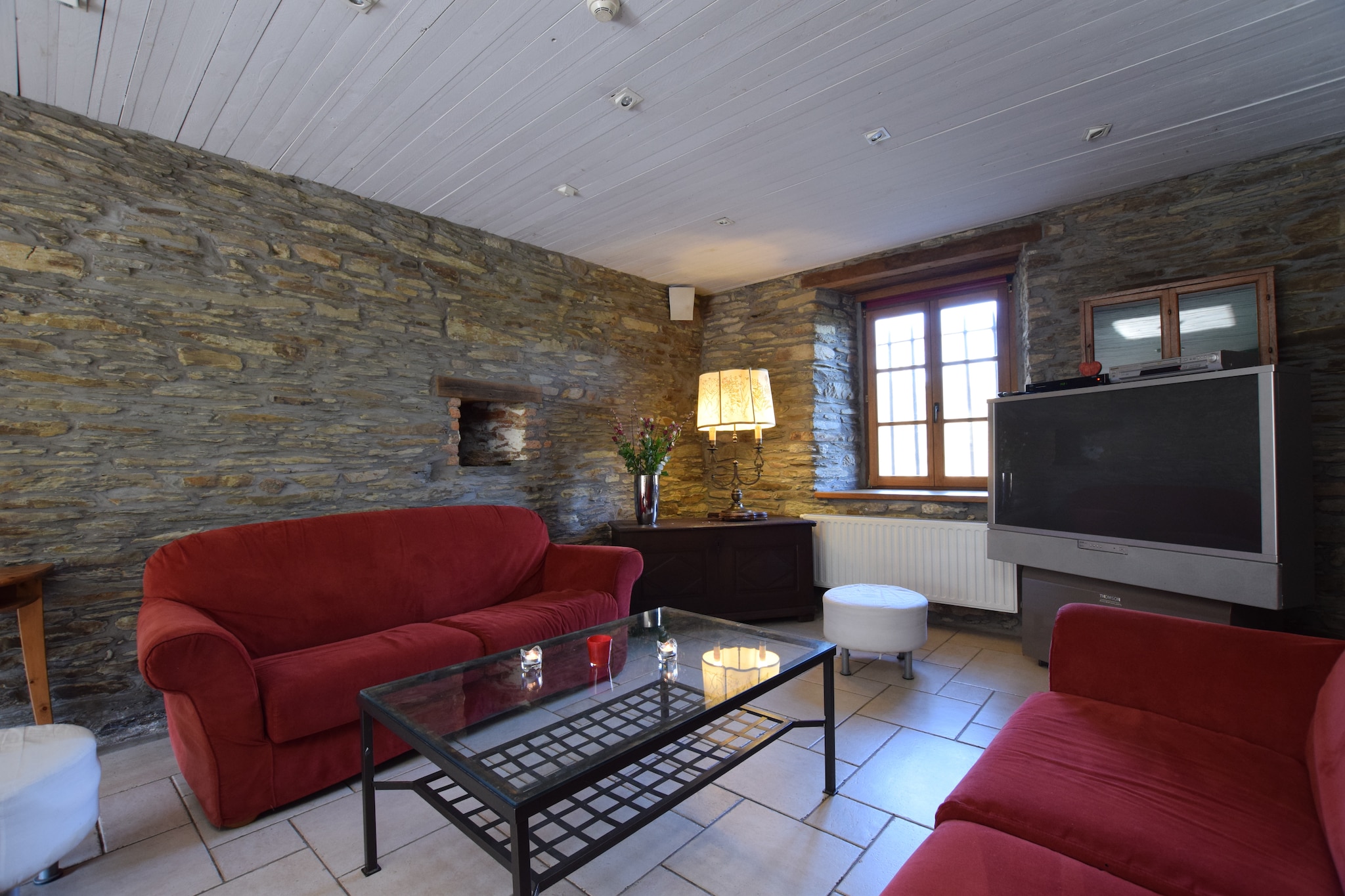 Perfect for group accommodation with up to 26 persons, this is an 8-bedroom holiday home in Tenneville. It has a private sauna and a private swimming pool to relax and refresh. You can organize a get-together or celebration here.



The river Ourthe, where canoeing and fishing are popular, is nearby. You can go walking in the region. In winter, the cross-country skiing tracks of Bailet are great. There is a lake at 1 km for a pleasant day out. Supermarkets are at 2 km if you wish to buy groceries. For an evening stroll, you can head to the town center at 5 km. La Roche-en-Ardenne is a tourist city that is worth visiting.



The wood-stove in the living room creates a cozy atmosphere when you spend a great time together. On the lovely furnished terrace, you can enjoy barbecuing for long hours. The garden is perfect to lie down reading a book or play ball games with children. For children, a children's bed, a high chair, and a boule's court are there. Parking is available.