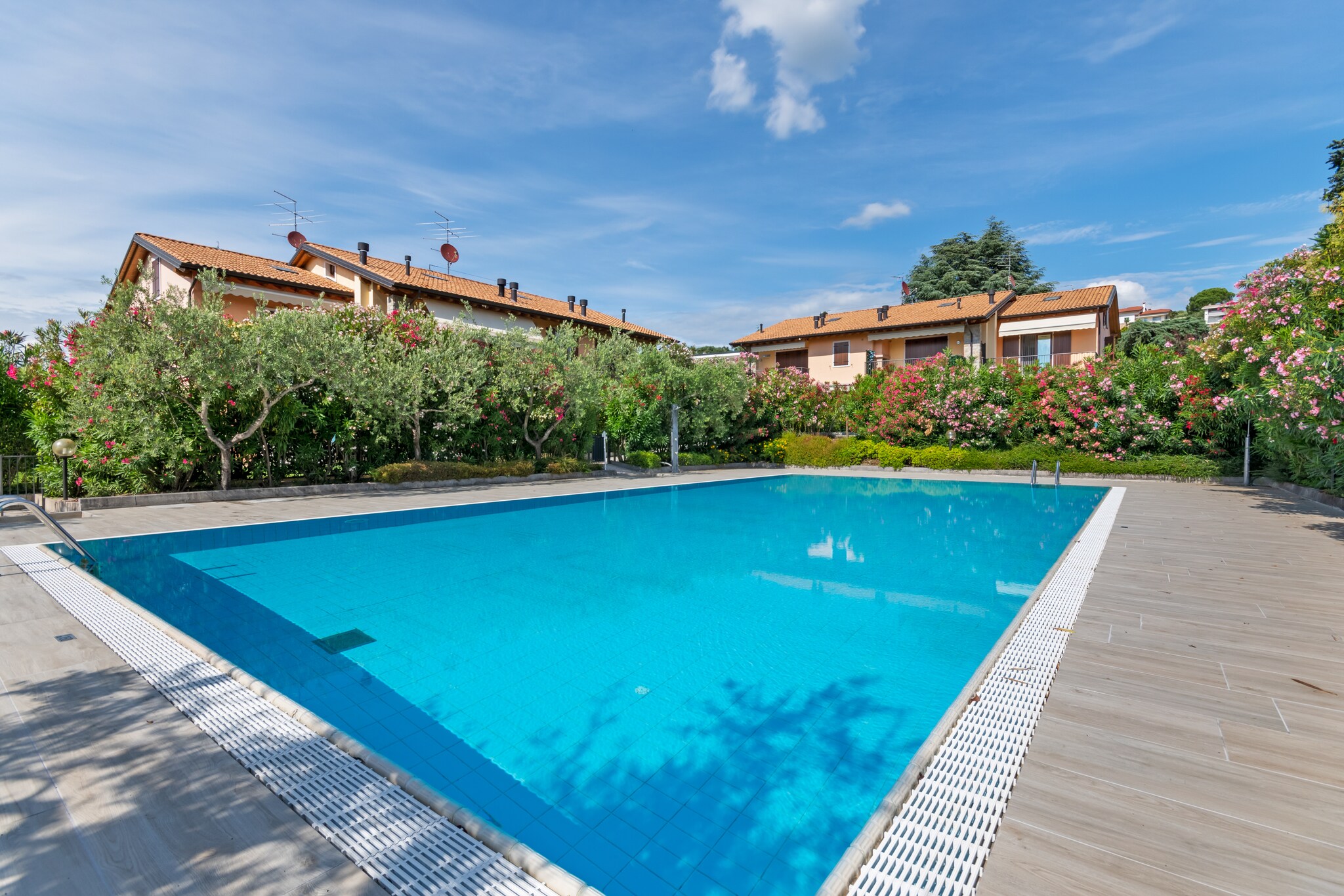 At a walking distance from the town center of Bardolino, this is a holiday home with 3 bedrooms and a lovely swimming pool. You can spend a relaxing and exotic vacation in the Italian Lakes region while staying here. It makes an ideal stay for a family or group of 7 persons.



The nearest restaurants and grocery stores are at walking distance, 0.6 km and 0.8 km away, respectively. For sightseeing and relaxation, you can go to the lake at 1 km. For a stroll in the evenings, the town center is also 1 km.



The holiday home has indoor heating and air-conditioning. In the living room, you can watch TV before retiring to bed at night. From the terrace, you can enjoy beautiful views of the mountainous surrounding and home-cooked meals. Children have ample secure space to play around in the fenced garden. Parking is available.