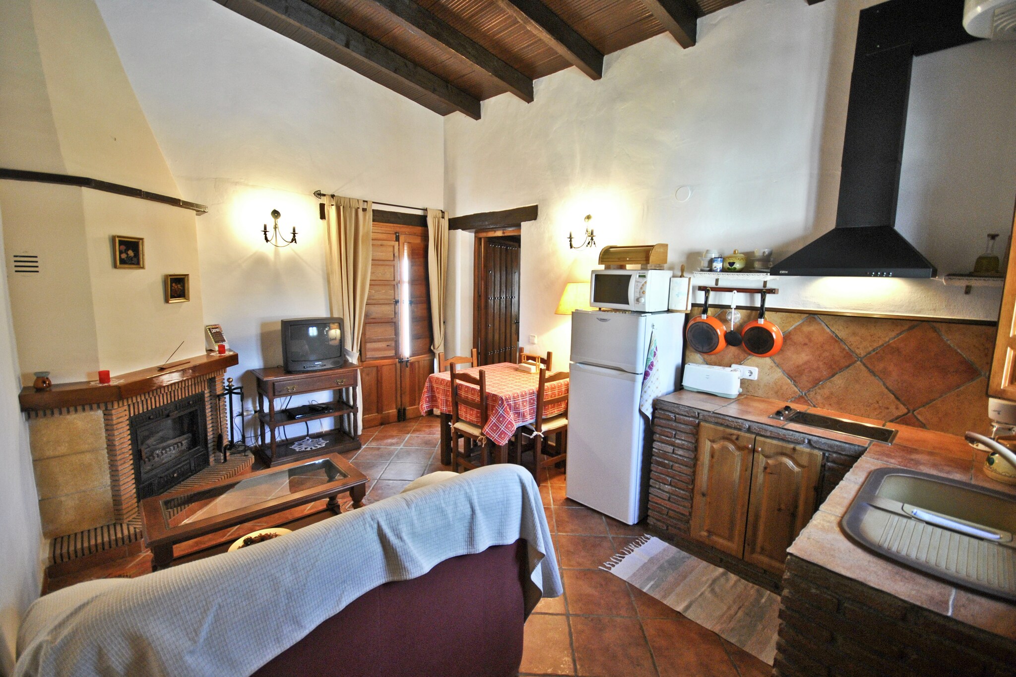 open kitchen(cooker(2 ring stoves, ceramic), combination microwave, fridge-freezer), Living/diningroom(TV, fireplace, DVD player), bedroom(double bed or 2 single beds, stove(oil)), bathroom(stove, shower, washbasin, toilet), washing machine(paid), heating(wood), terrace, garden, garden furniture, parking, swimming pool(shared with other guests, 10 x 5 m.), children\'s bed(on request)