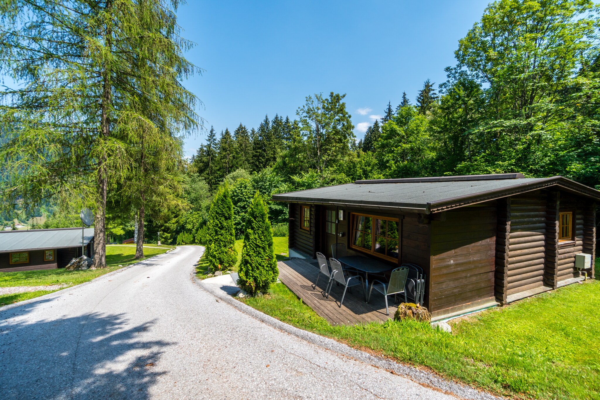 Ground floor: (hallway, Living room(TV(satellite), radio), open kitchen(dining table, oven, dishwasher), bedroom(bunk bed), bedroom(double bed), bathroom(shower, washbasin, toilet, heating(floor heating)))\n\nBasement: (bedroom(2x single bed), bedroom(5x single bed), bathroom(shower, washbasin, toilet))\n\nheating(central), terrace(private), garden(private), garden furniture, BBQ, 2x parking, high chair