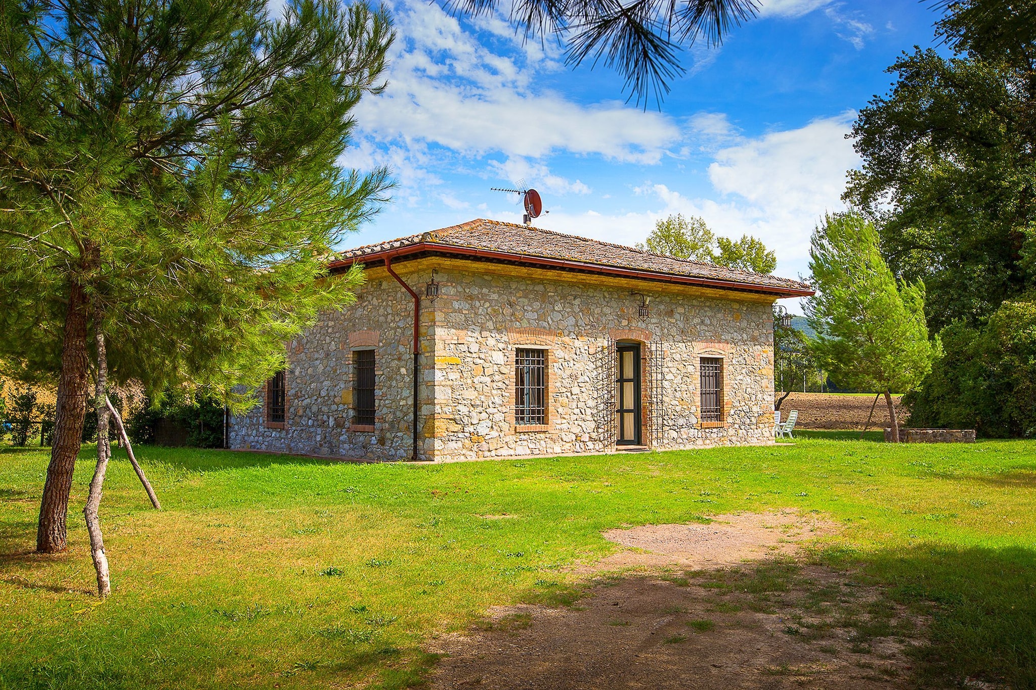 A rustic house set in the Tuscan landscape.