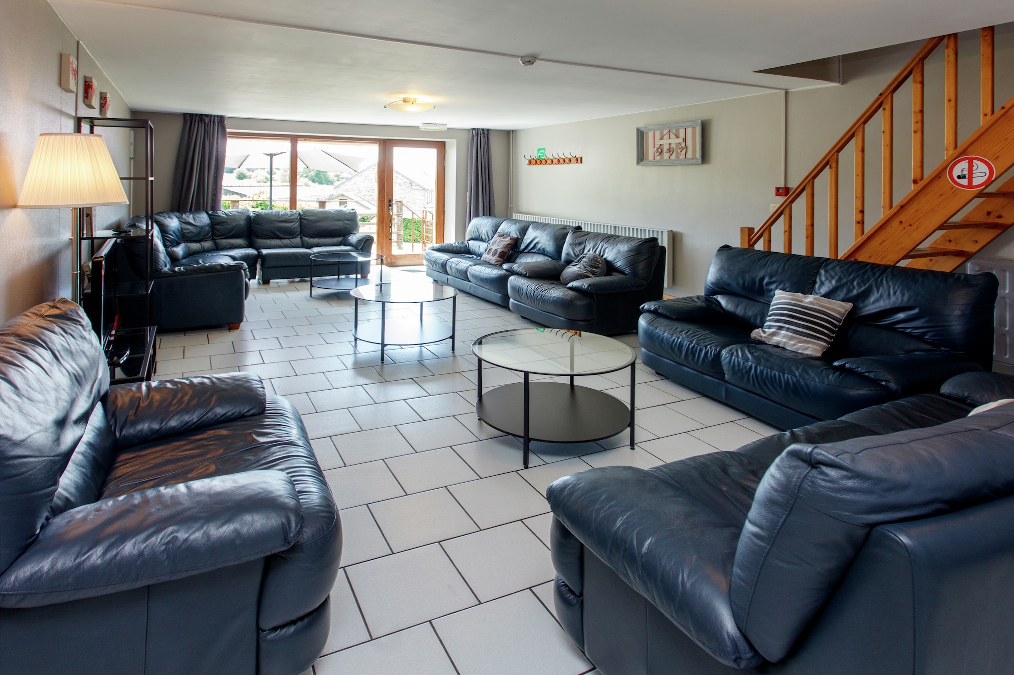 This pet-friendly cottage in Manhay, in the Belgian Ardennes region, has 7 bedrooms and can accommodate up to 21 people. On the private terrace, you can spend time around a hot barbecue and linger with a glass of wine. It is ideal for organizing a get-together with family and friends.
Ardennes is a wooded plateau covering part of the ancient Forest of Ardennes and spreading across Belgium. Besides exploring the Ardennes Forest, you can visit the health resort of Spa, the Ourthe river with picturesque views, and the Popsa Coo theme park with rides & shows. The scenic Coo Waterfalls and Euro Space Center are also worth a visit.
There is a private spacious garden with sunbathing area and garden furniture to enjoy the hours of sunshine and fresh air. Children will love the play equipment. The oven in the kitchen is perfect to bake cakes and pizzas whenever you wish. You have a coffee machine to grab a quick cup at any time. 2 pets are allowed for a small fee.