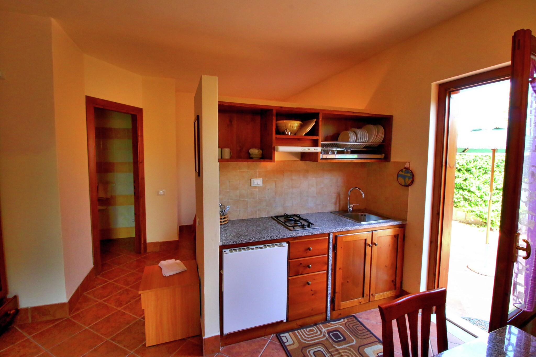 Your Parghelia Countryside Oasis
Nestled on a verdant hill near the enchanting "Coast of the Gods" in Calabria, this countryside mansion offers a serene escape. Your ground-floor apartment features an open kitchen equipped with a stove, dishwasher, and washbasin, alongside a comfortable living room with a TV. Enjoy privacy on your dedicated terrace, while a shared, fenced garden provides a communal space with furniture, parking, deckchairs, and parasols. Air conditioning ensures comfort, and the property promises beautiful views. An exclusive restaurant on the premises serves local flavours and delicacies, available only to guests.

Explore the Coast of the Gods
Situated near the renowned "Coast of the Gods," this location serves as an ideal base to discover Calabria's stunning coastline, famed for its crystal-clear waters and picturesque beaches. The sea is conveniently located just 3 km away, inviting days of sun and swimming. The charming town centre, also 3 km distant, offers general supplies, nightlife, and public transport access. For additional exploration, tourist information is available 2 km away, guiding you to the region's hidden gems and breathtaking panoramic views.

Savour Authentic Calabrian Delicacies
A highlight of your stay is the on-site restaurant, exclusively for guests, where you can indulge in a delightful array of local flavours and delicacies without leaving the premises. Beyond the property, additional dining options are readily available, with restaurants situated just 2 km away in the nearby area. These provide further opportunities to experience the rich and authentic culinary traditions of Parghelia and the wider Calabrian region.