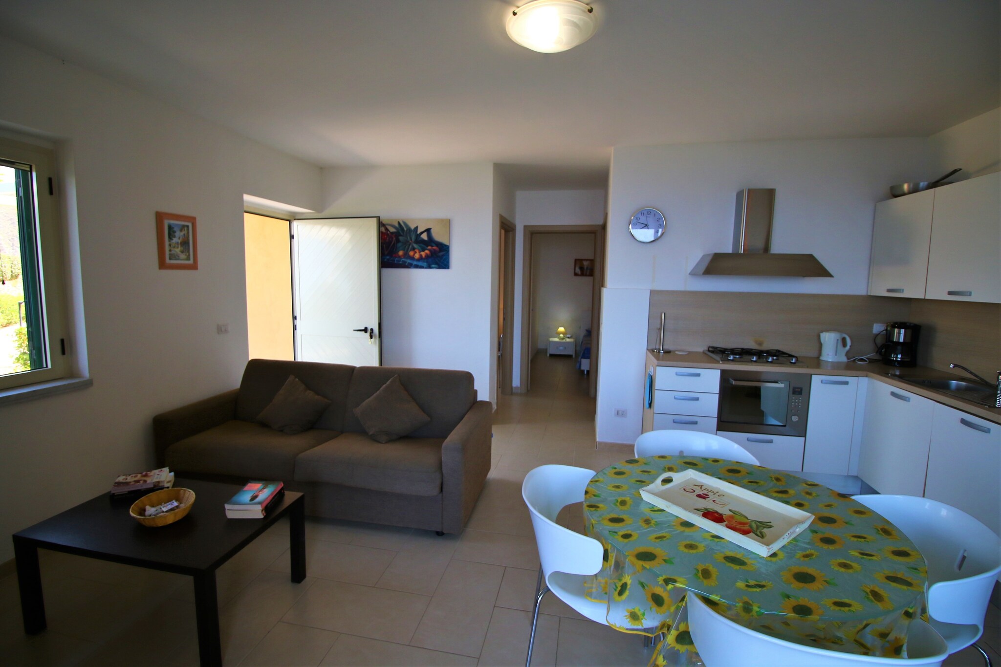 An optional utilities and service fee of EUR 80,00 will be charged before your arrival. Details are given below.<br> Coastal Charm with a Touch of Tranquility
Tucked away on a lush hillside in the serene village of Parghelia, this stylish 2-bedroom ground-floor apartment is the perfect coastal escape for up to 4 guests. With a stunning view of the Tyrrhenian Sea and the historic town of Tropea, your stay promises a mix of scenic beauty and absolute comfort. The bright and breezy interiors, air-conditioned bedrooms, and private terrace with garden furniture make this home a perfect spot for families seeking rest and rejuvenation. Ideal Location for Exploration
Just 1 km from the beach and Tropea's charming town center, this apartment places you near the heart of Calabria's coastal treasures. Explore the Eolian Islands by boat, lounge at secluded bays, or stroll through coastal caves. Local supermarkets and public transport are only 800 meters away, giving you easy access to daily conveniences. The famed Tropea Marina and crystal-clear beaches are just a short drive, perfect for sun-drenched adventures. Refresh and Recharge
Take a dip in the shared swimming pool (open seasonally), unwind on the terrace, or enjoy an alfresco meal while soaking in panoramic sea views. The home includes a modern kitchen, washing machine, and WiFi for a stress-free stay. Please note: pets are not permitted and the home is reserved for families or mature travelers over 21. Late arrivals after 7 PM incur a â‚¬50 surcharge. Come experience peaceful, upscale living just moments from Calabria's sparkling coastline. <br><b> Optional Utilities & Service Package </b><br><b> An optional utilities and service package of EUR 80,00 </b> can be selected prior to your arrival. You will receive a separate communication with the payment link should you wish to include it.<br>This package ensures a seamless stay and conveniently covers services such as final cleaning, utility consumption, service support, and protection against minor damages or incidental costs during your stay.<br>Guests who prefer may manage these services independently, provided the property is returned in good order at check-out.