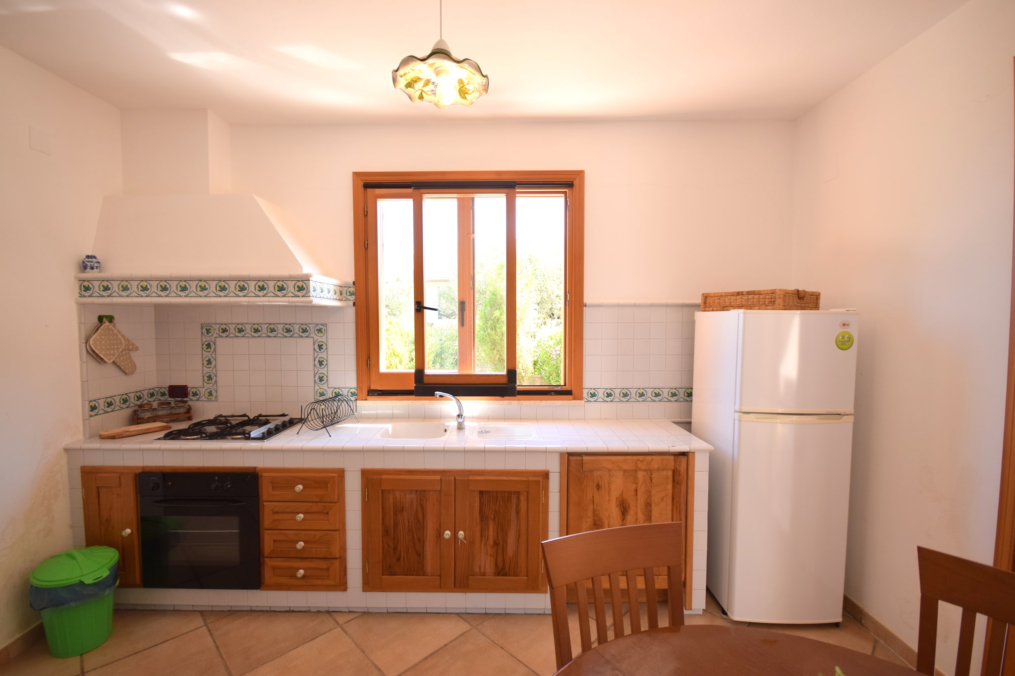 Ground floor: (Large kitchen(hob, electric kettle, cooker(ceramic), oven, dishwasher, fridge-freezer), Living/diningroom(decorative fireplace, air conditioning), bedroom(double bed), bedroom(small double bed(140 x 200 cm)), bedroom(2x single bed), bathroom(shower, washbasin, toilet, bidet), TV(satellite), balcony or terrace, air conditioning, terrace(private))\n\nshower(outside), washing machine, garden(private, fenced), garden furniture, BBQ, parking, high chair