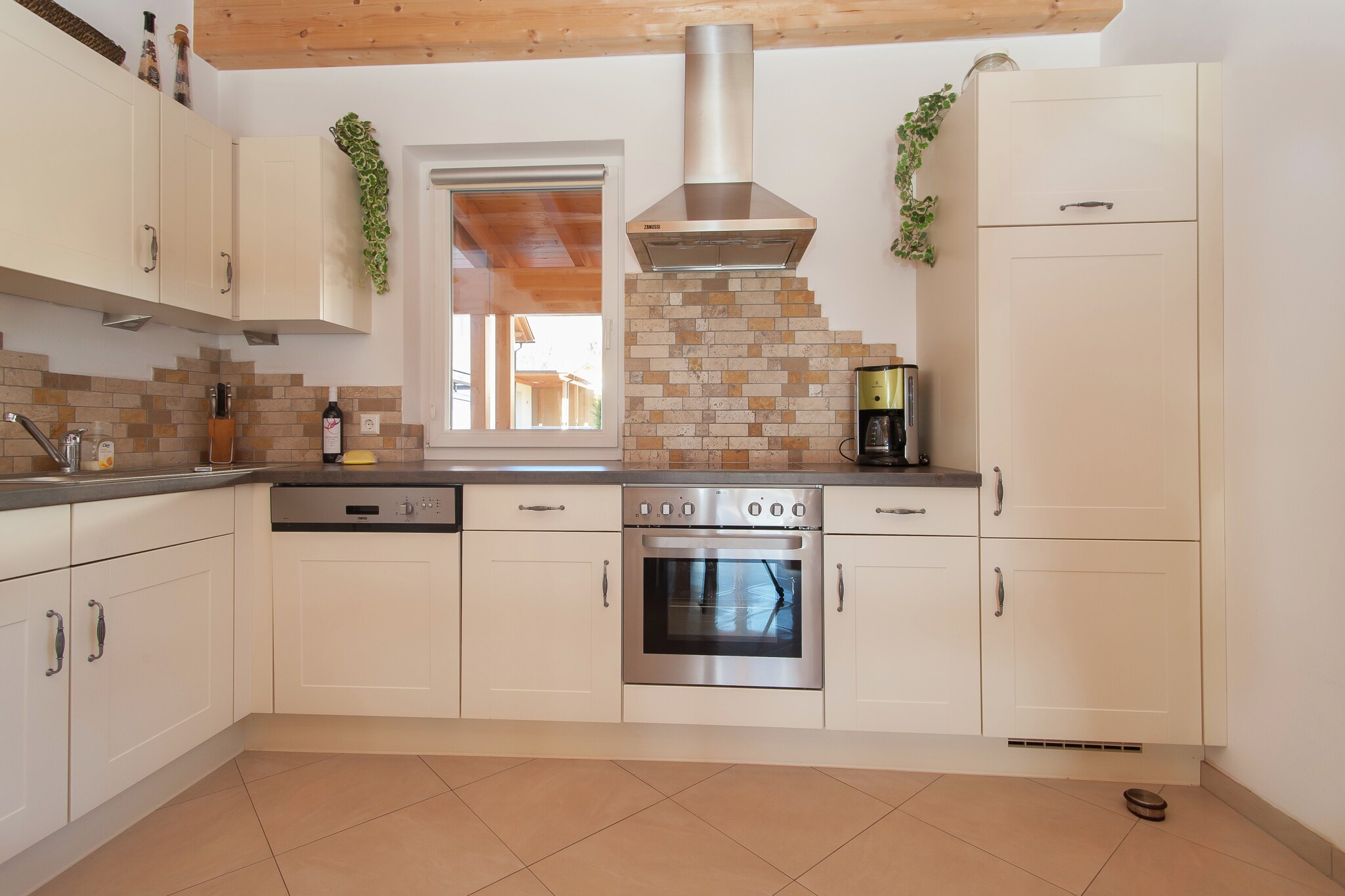 Ground floor: (open kitchen(cooker(ceramic), coffee machine, oven, microwave, dishwasher, fridge-freezer), Living/diningroom(double sofa bed, TV, dining table, fireplace, DVD player, CD player, garden doors), toilet, ski storage(carport, BBQ), terrace(roofed), garden)\n\nOn the 1st floor: (bedroom(double bed), bedroom(bunk bed, radio, balcony), bathroom(bath tub, shower, washbasin, toilet), tumble dryer, washing machine, balcony)\n\nLiving/diningroom, bathroom, carport, heating(electric, floor heating), garden furniture, parking, children\'s bed, high chair