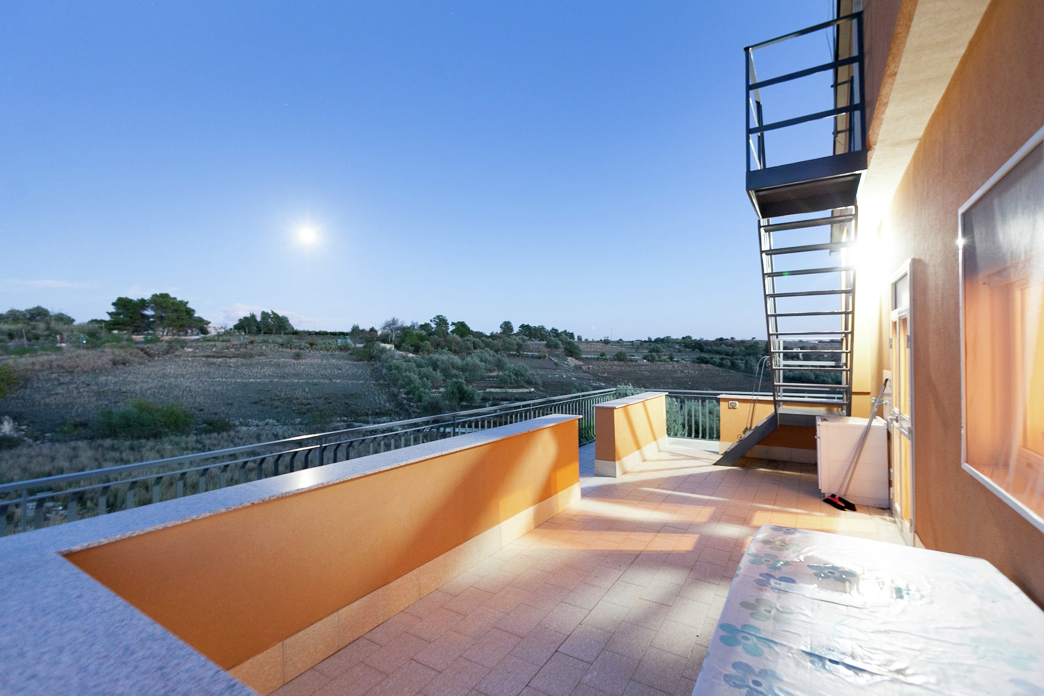 This holiday home has 2-bedrooms and can accommodate up to 4 people. Located near the Mediterranean Sea,it has a barbecue to cook tasty dishes and have a gala time.
The sea is at a distance of 10 km.Syracuse, Eloro, Megara are the major archaeological sites nearby.The town center,restaurants and general supplies are at a distance of 6.5 km. Public transport is available at a distance of 6.5 km. There is a public swimming pool at a distance of 6.5 km.
It has a modern and fully equipped open kitchen. Parking available on the premises.The living room and bedrooms have luxurious interiors and tasteful decor.
The nearest airport is Catania Fontanarossa and is at a distance of 30 km. While, the airport of (Ryan Air airport Comiso is 57 km away.