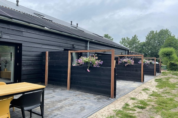 Gezellig vakantiehuis met tuin op 900m van het strand in Vrouwenpolder - thumbnail 1